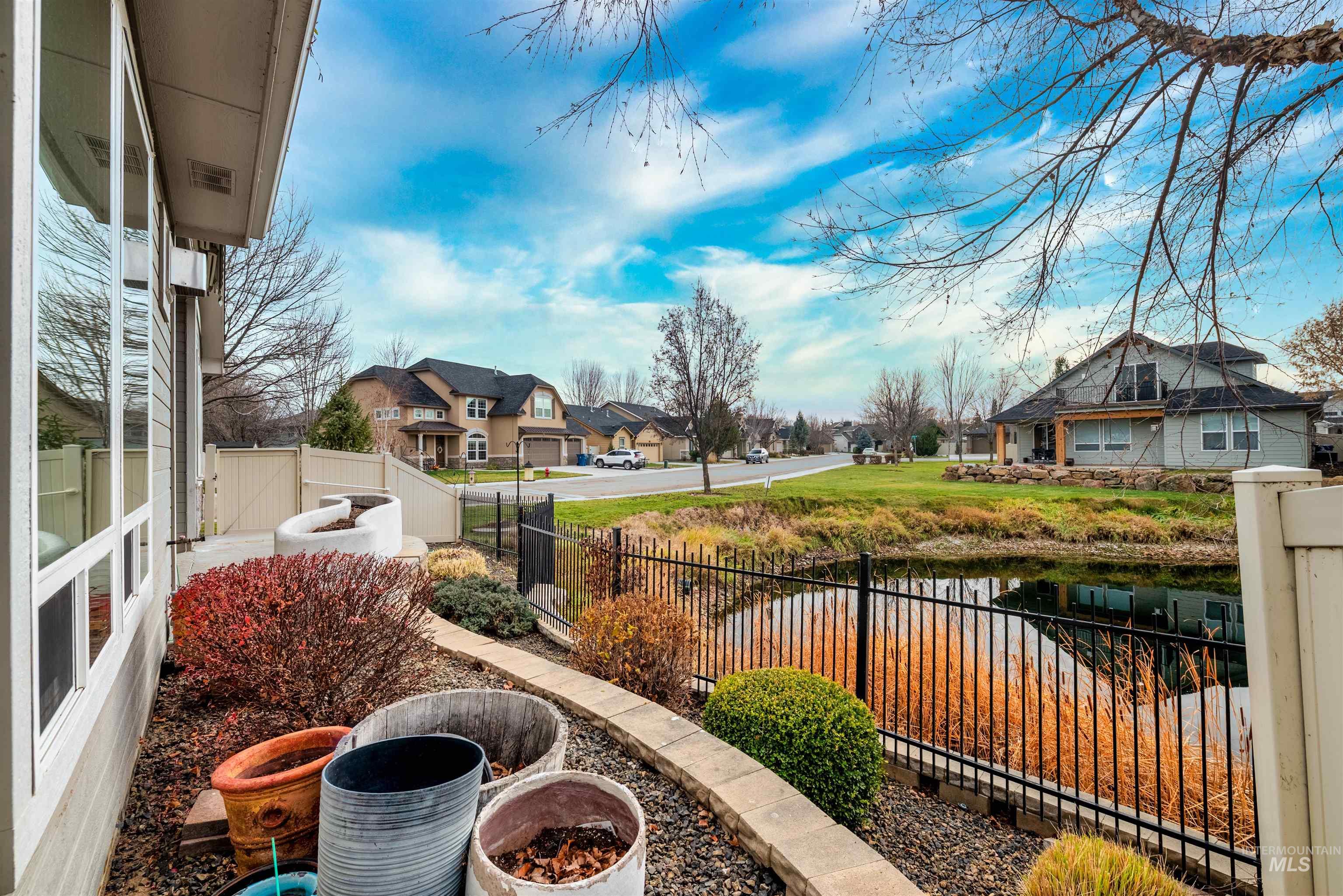 Fenced yard with a residential view and a water view