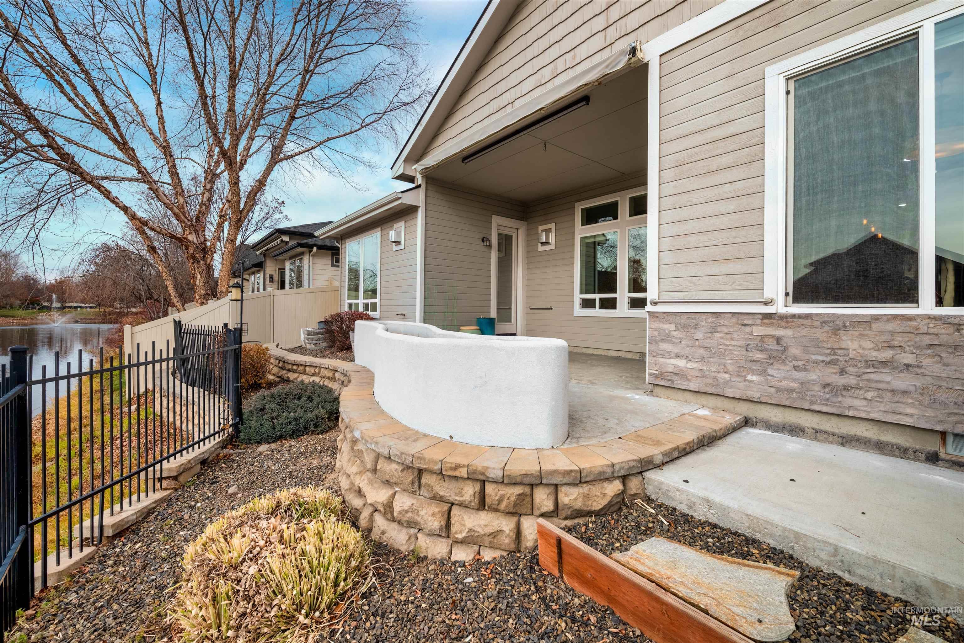 Fenced backyard with a patio and a water view