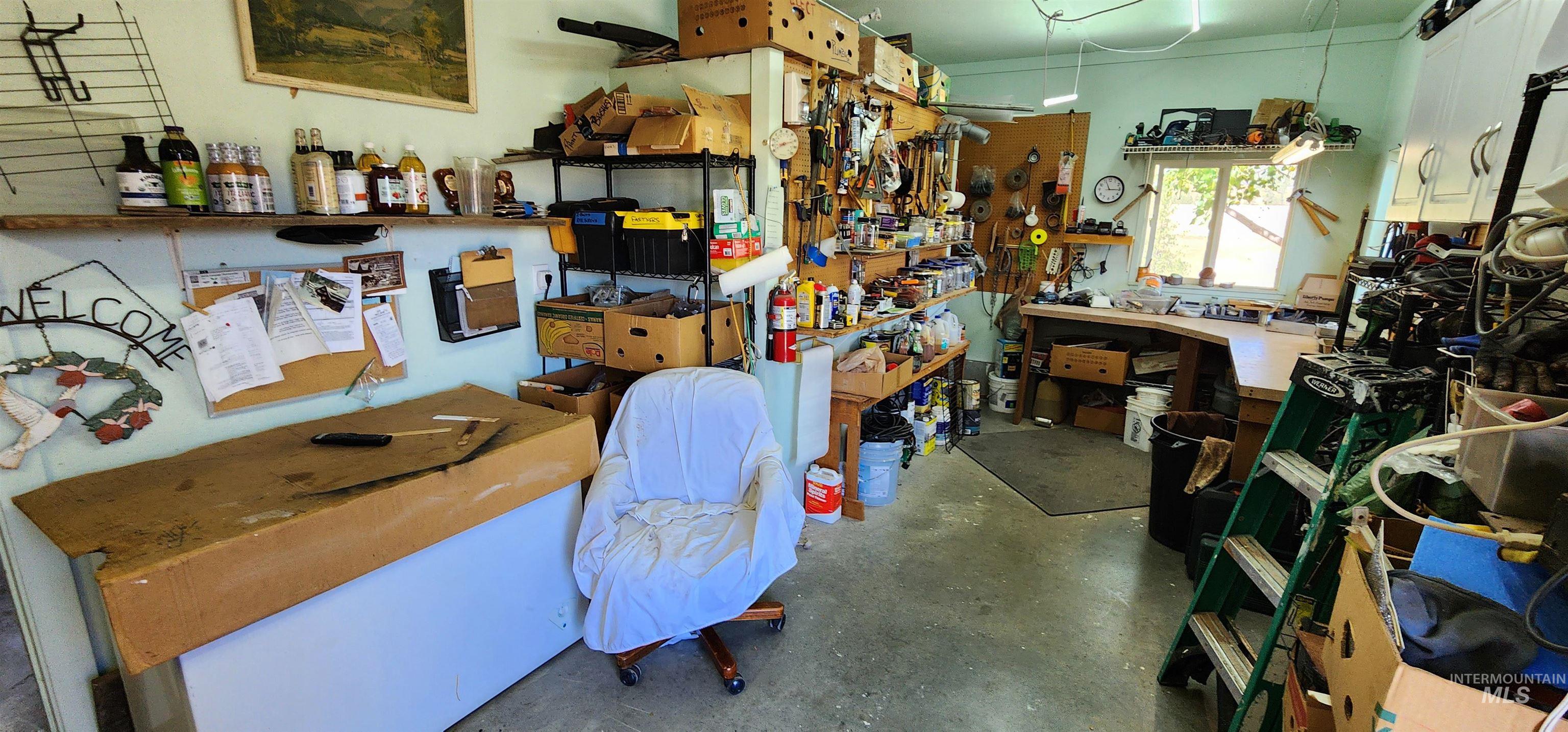 Miscellaneous room featuring a workshop area and concrete flooring