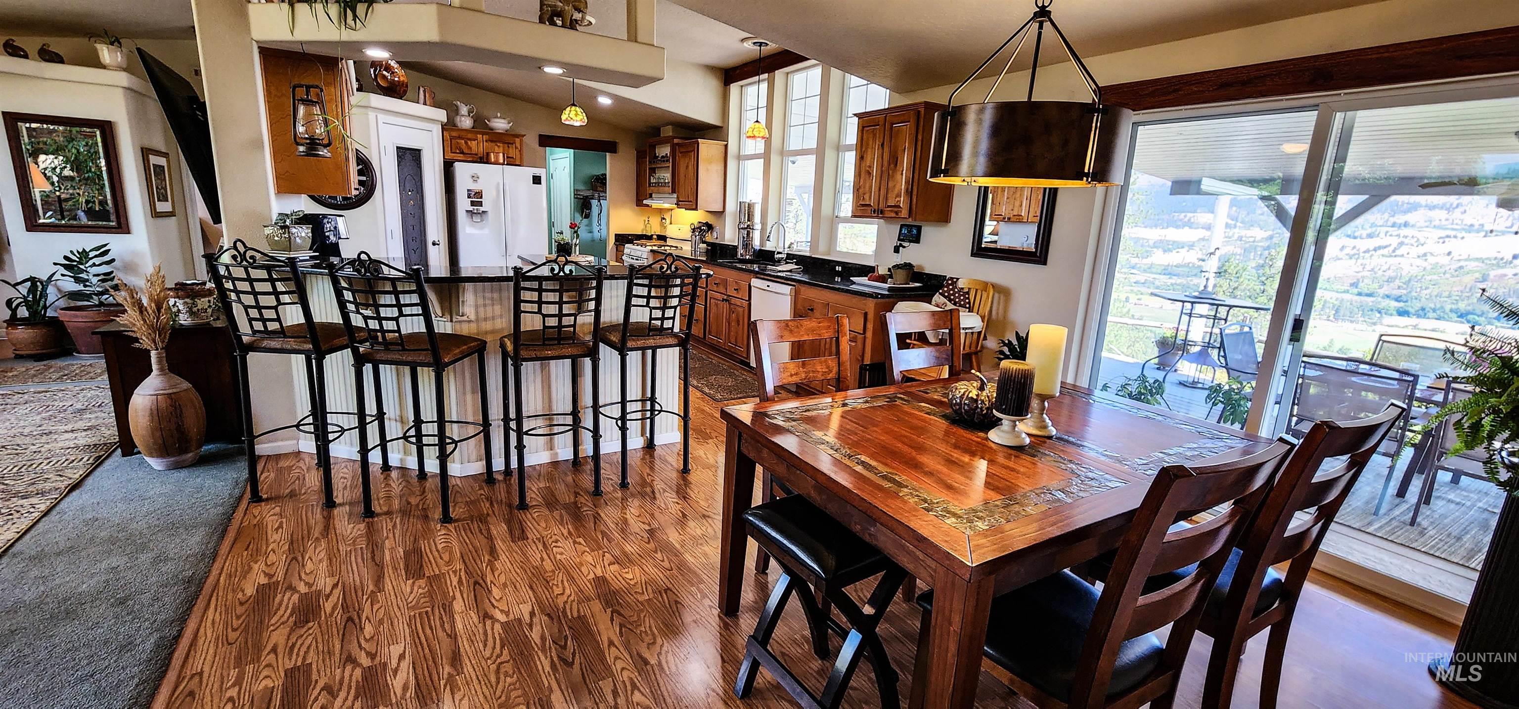 Dining area with dark wood-style flooring