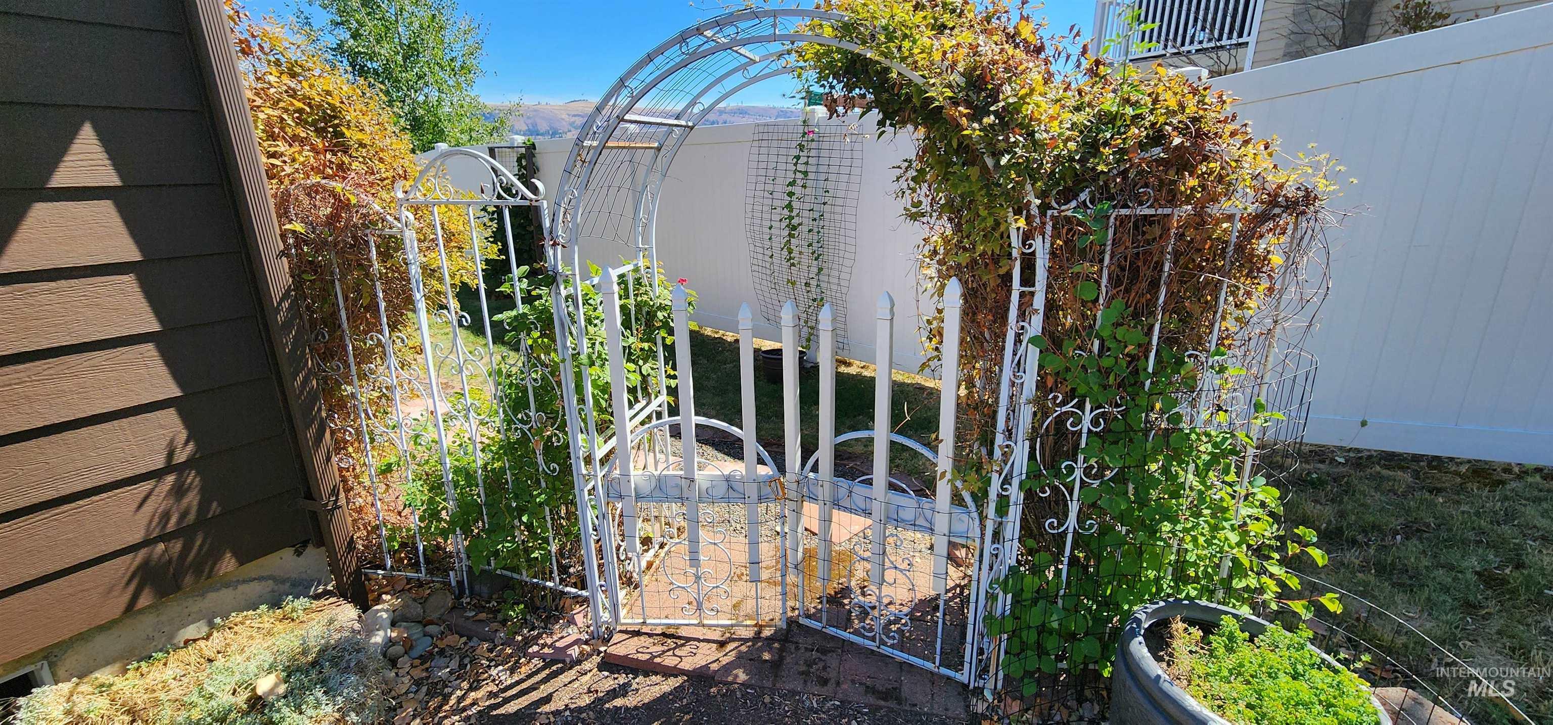 View of side of property with a gate