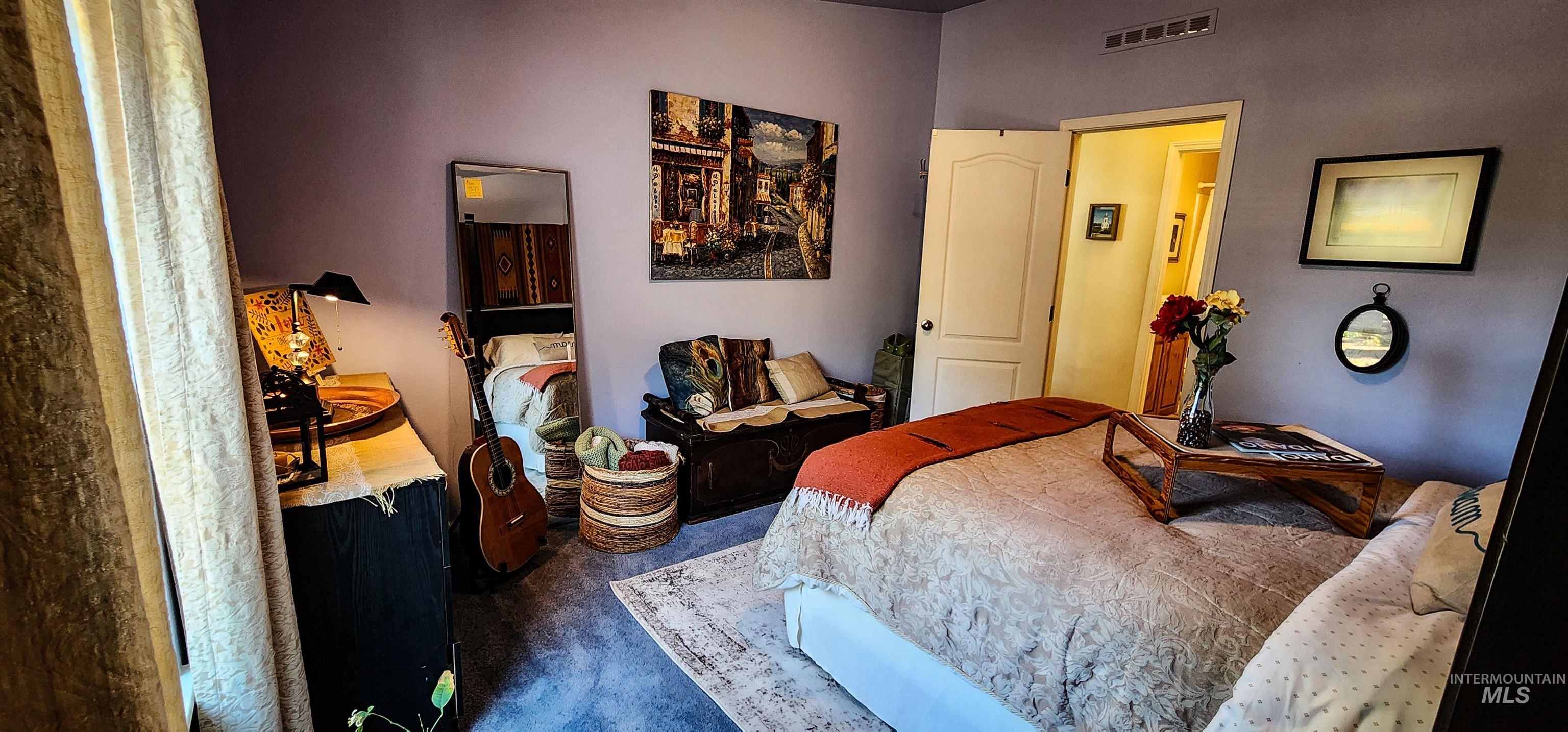 Bedroom featuring dark colored carpet