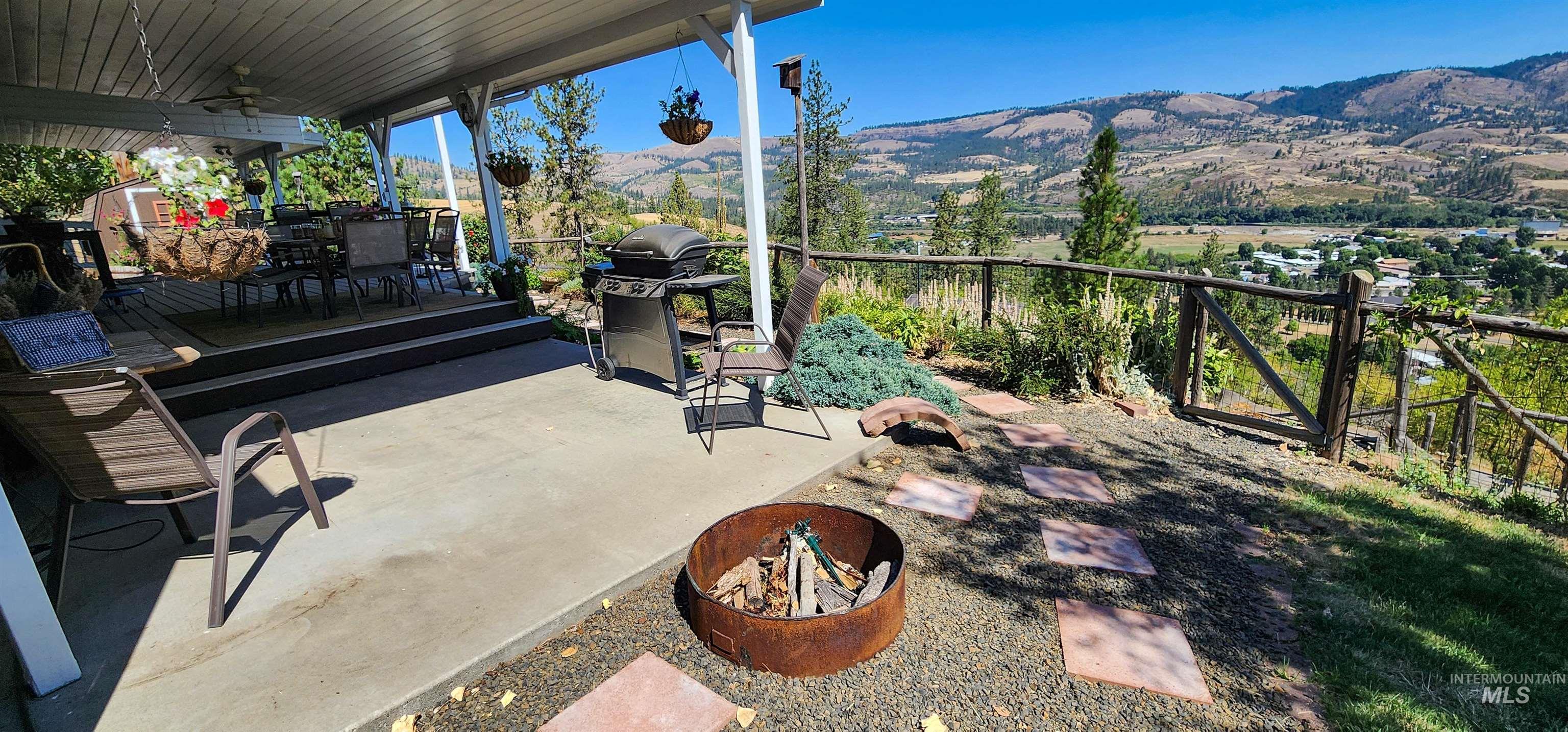 View of patio with a deck with mountain view and ceiling fan