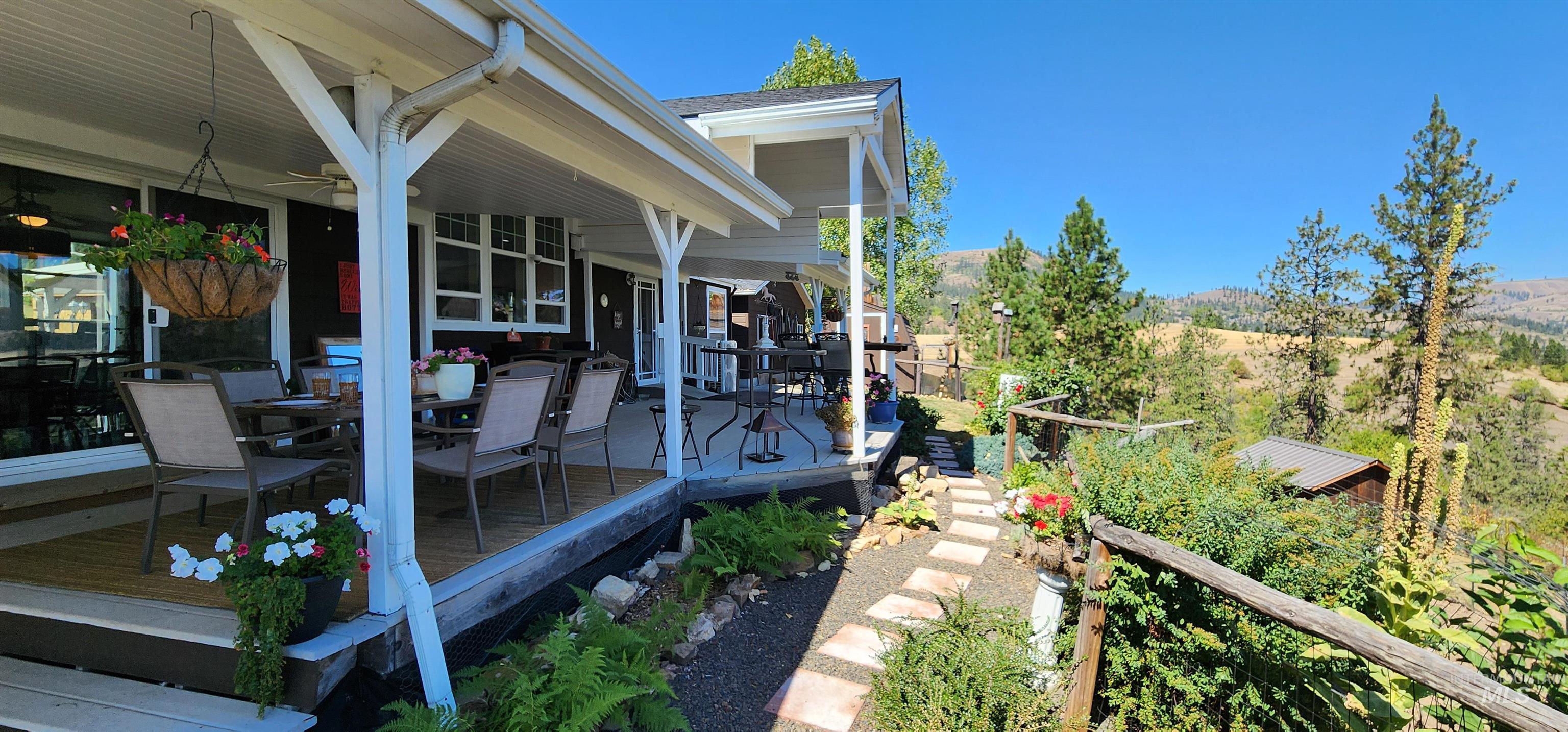 View of yard with outdoor dining area and a wooden deck