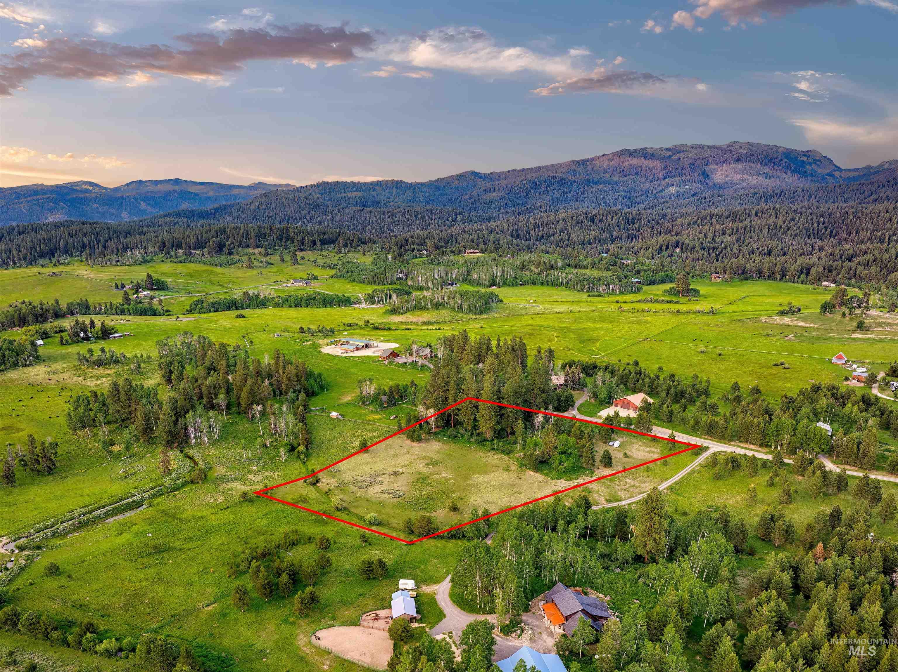 Aerial view at dusk of property boundaries highlighted, a mountain view, a view of countryside, and a forest view