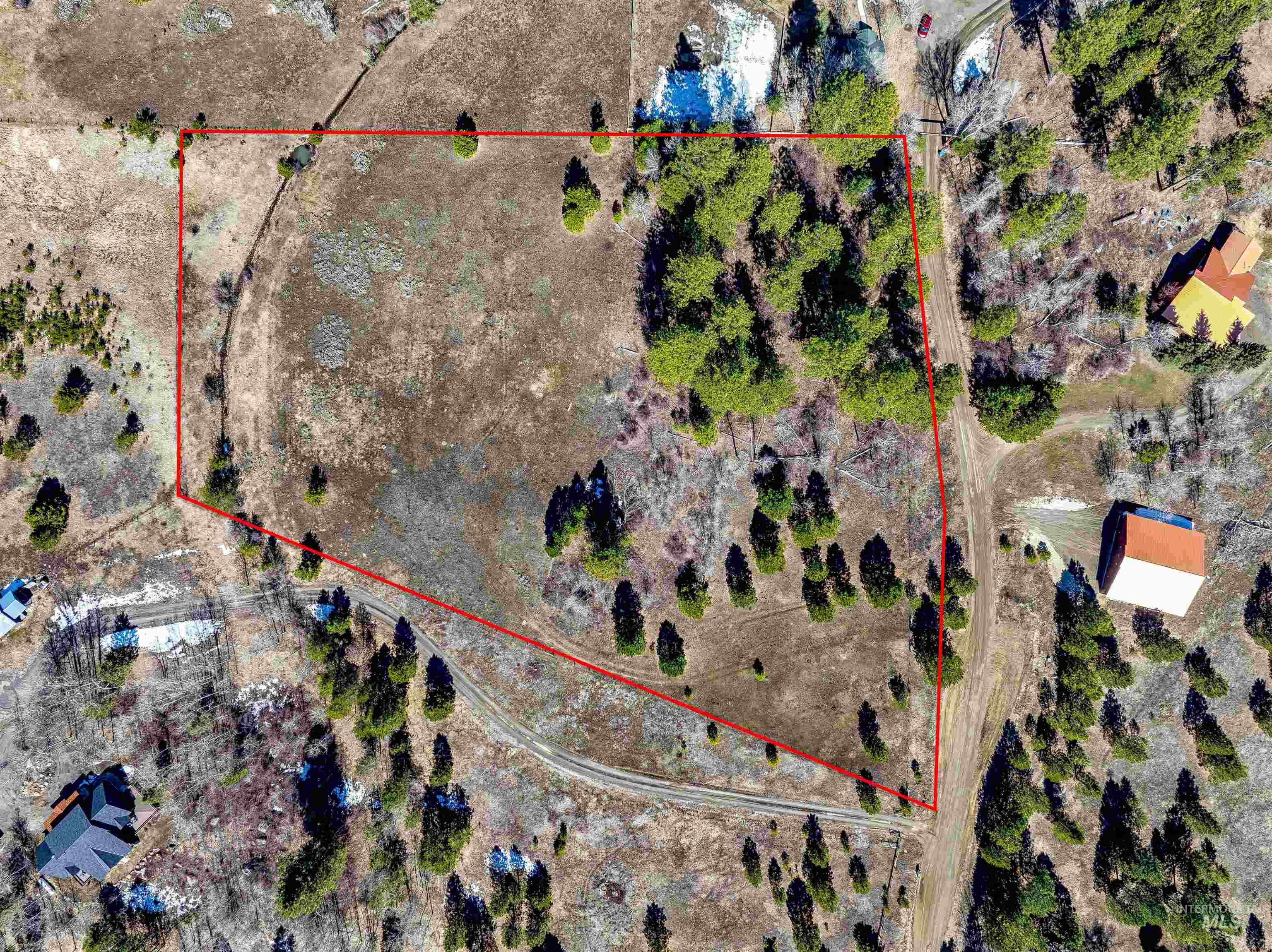 Aerial view of sparsely populated area featuring property parcel outlined