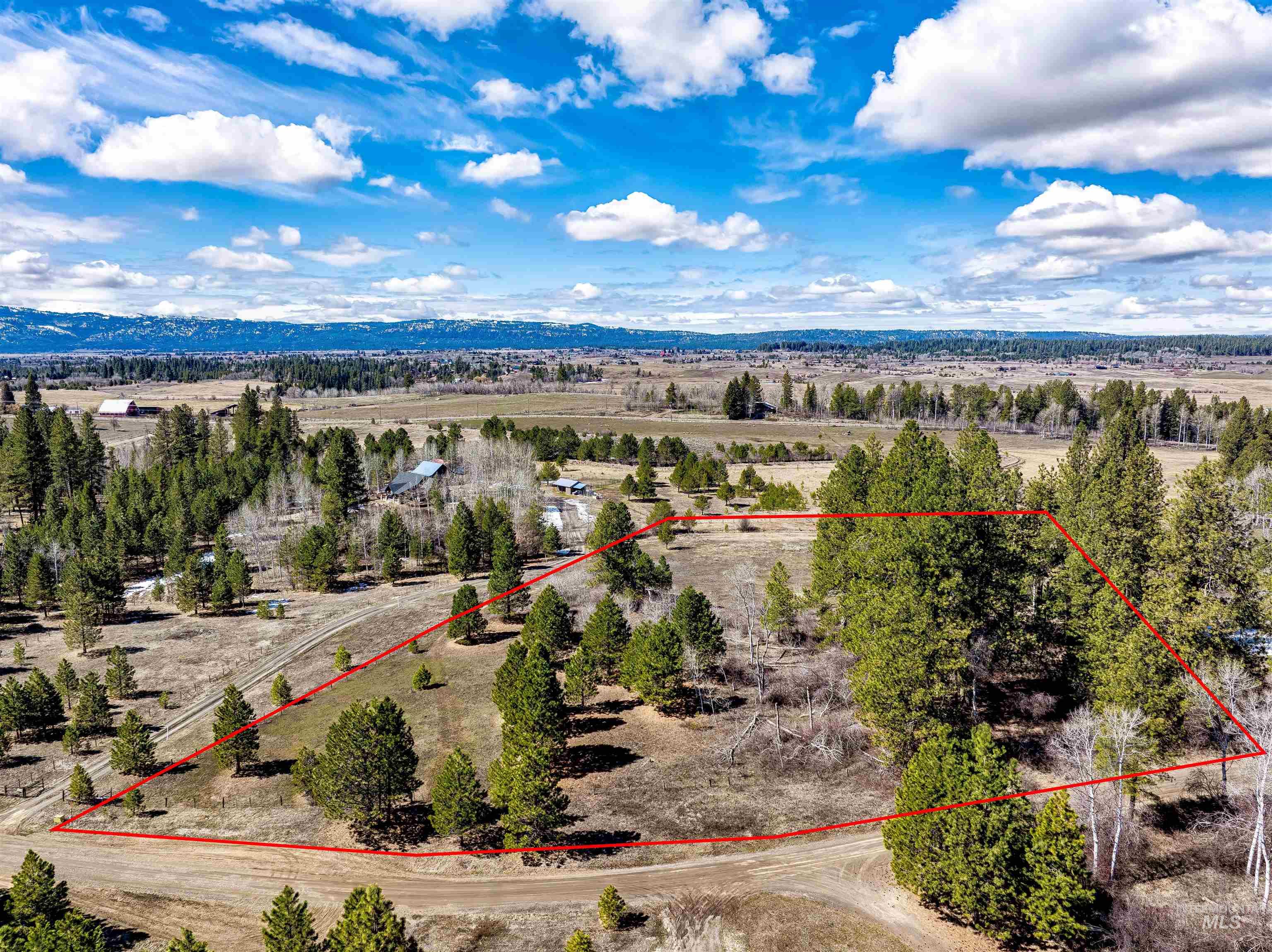 Aerial view of sparsely populated area with property parcel outlined