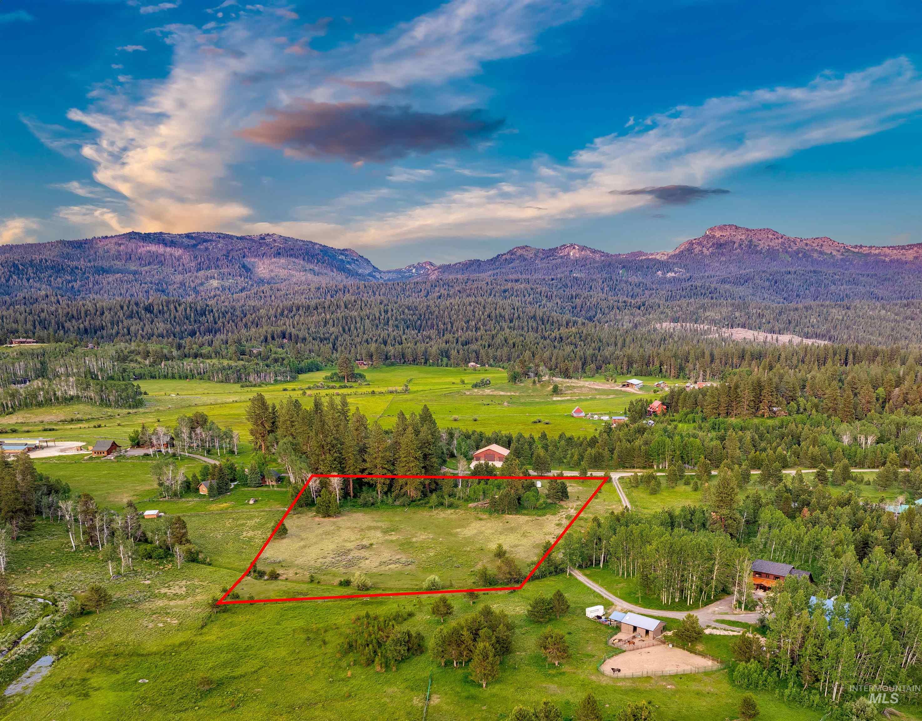 Aerial view of property's location featuring a mountainous background and property boundaries highlighted
