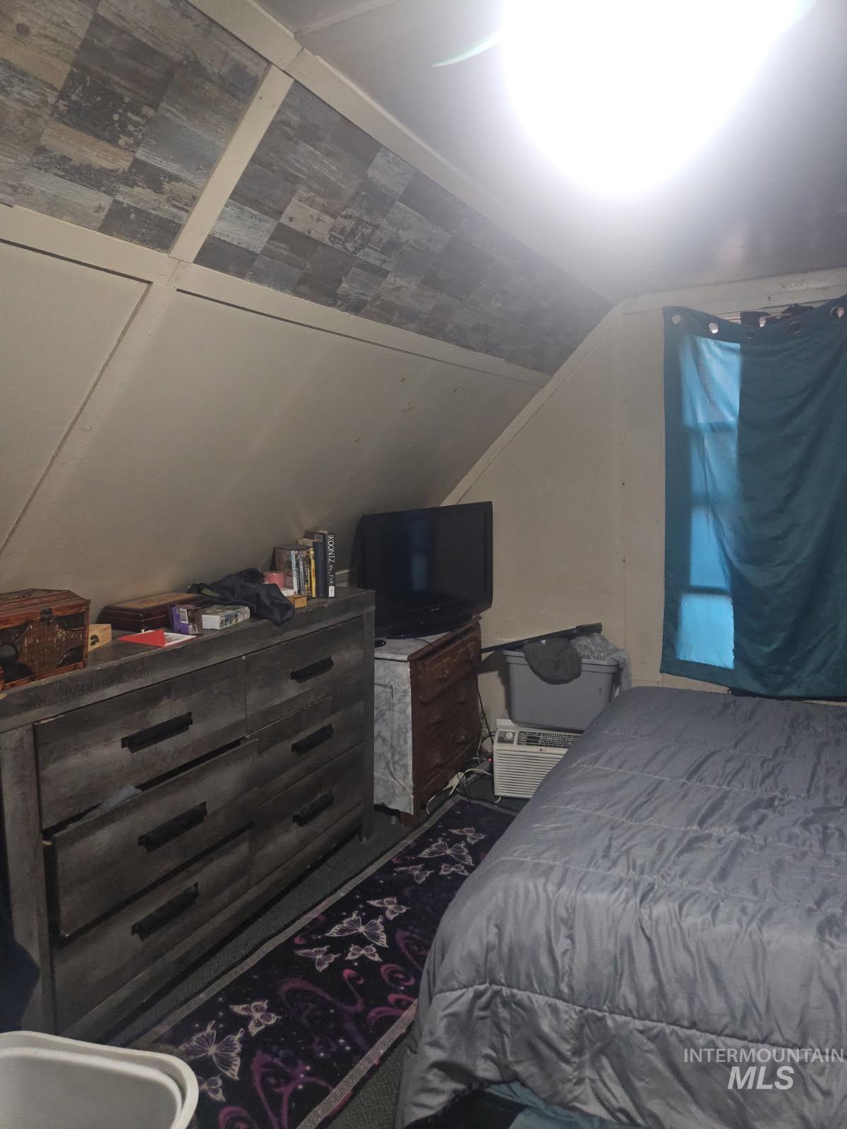 Bedroom featuring lofted ceiling