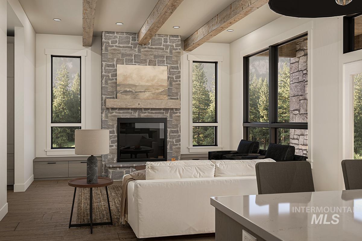 Living area with healthy amount of natural light, wood-type flooring, beam ceiling, recessed lighting, and a fireplace