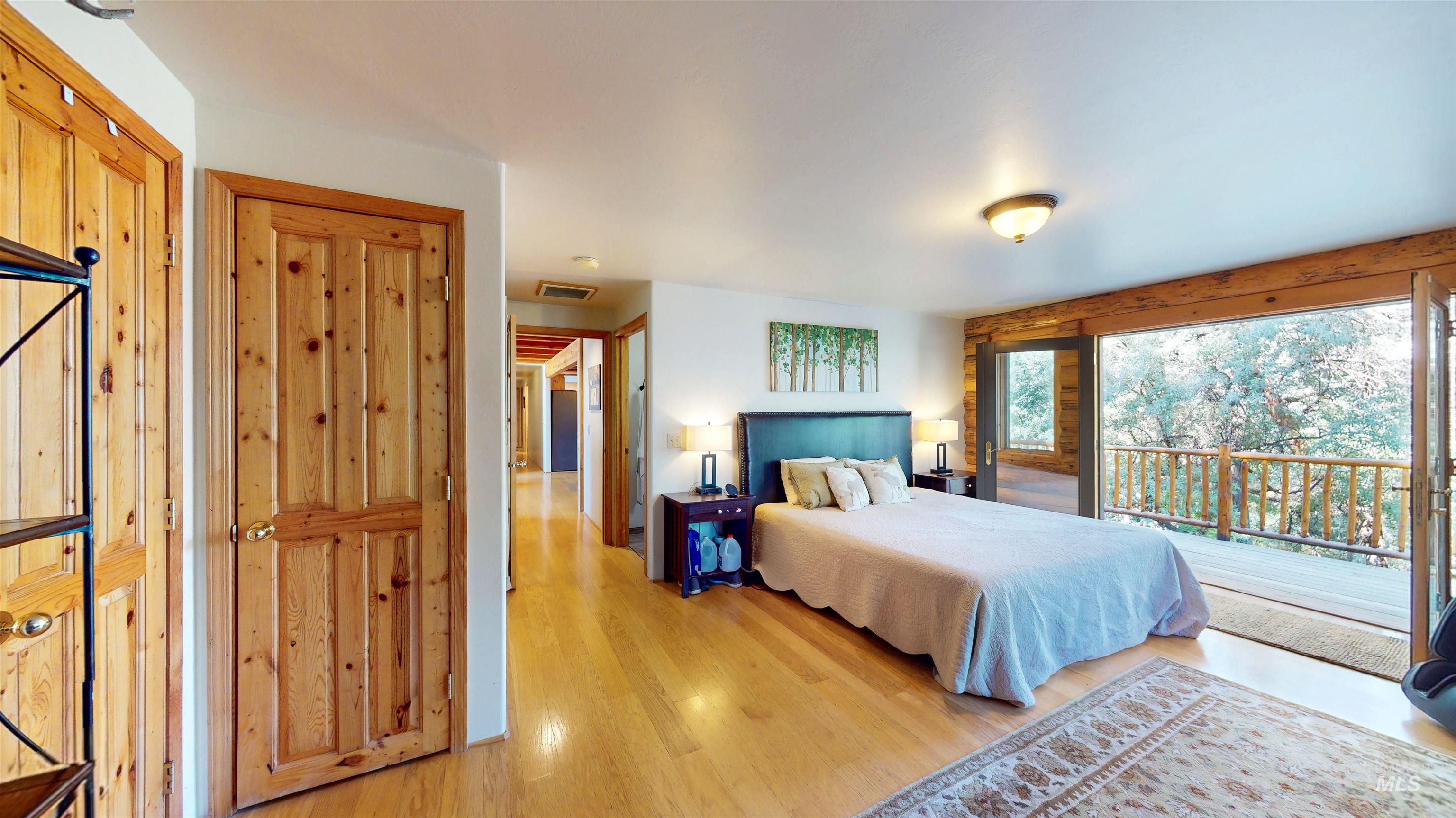 Bedroom featuring access to outside and light wood-style floors