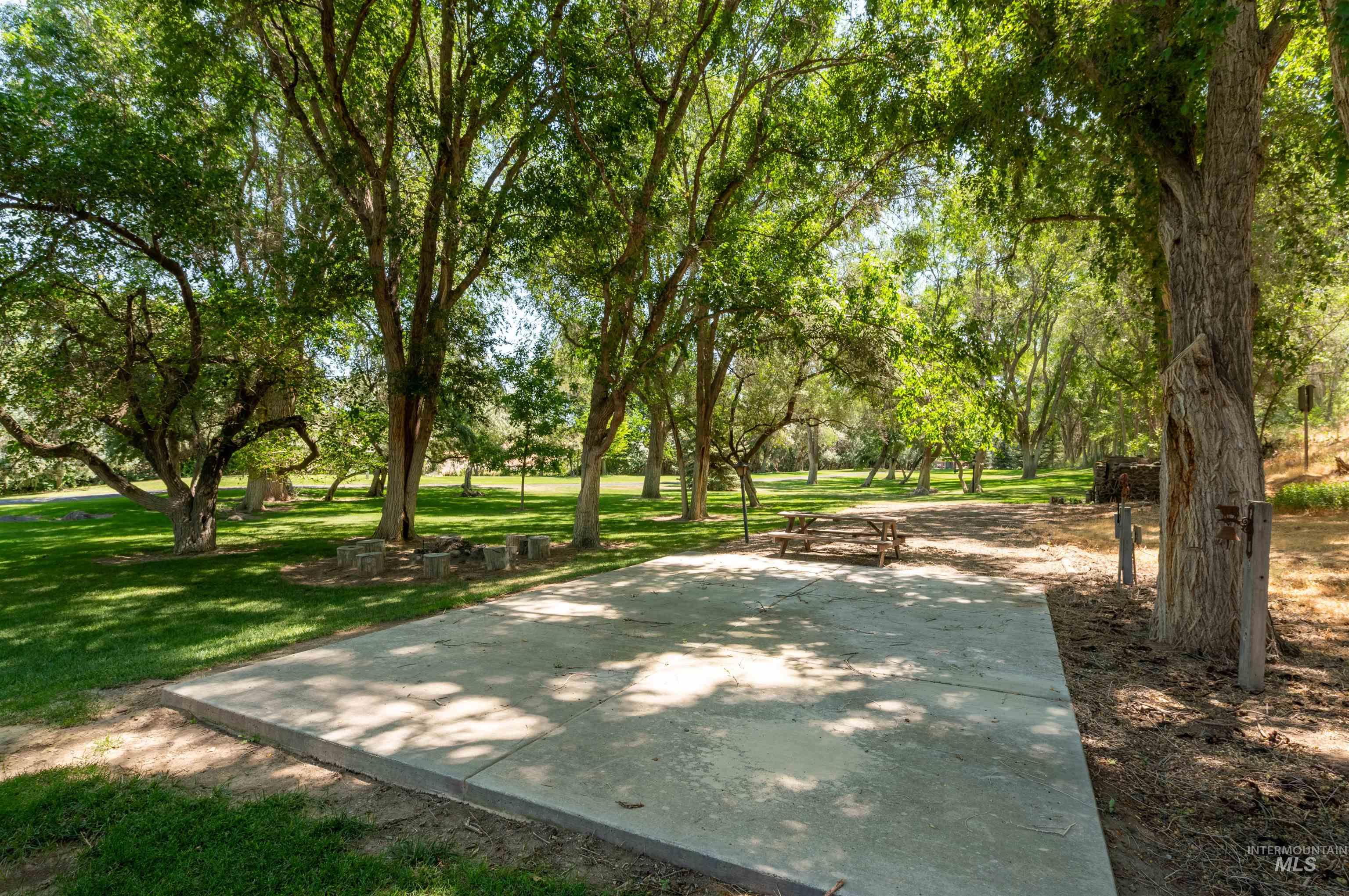 View of community with a yard and view of wooded area