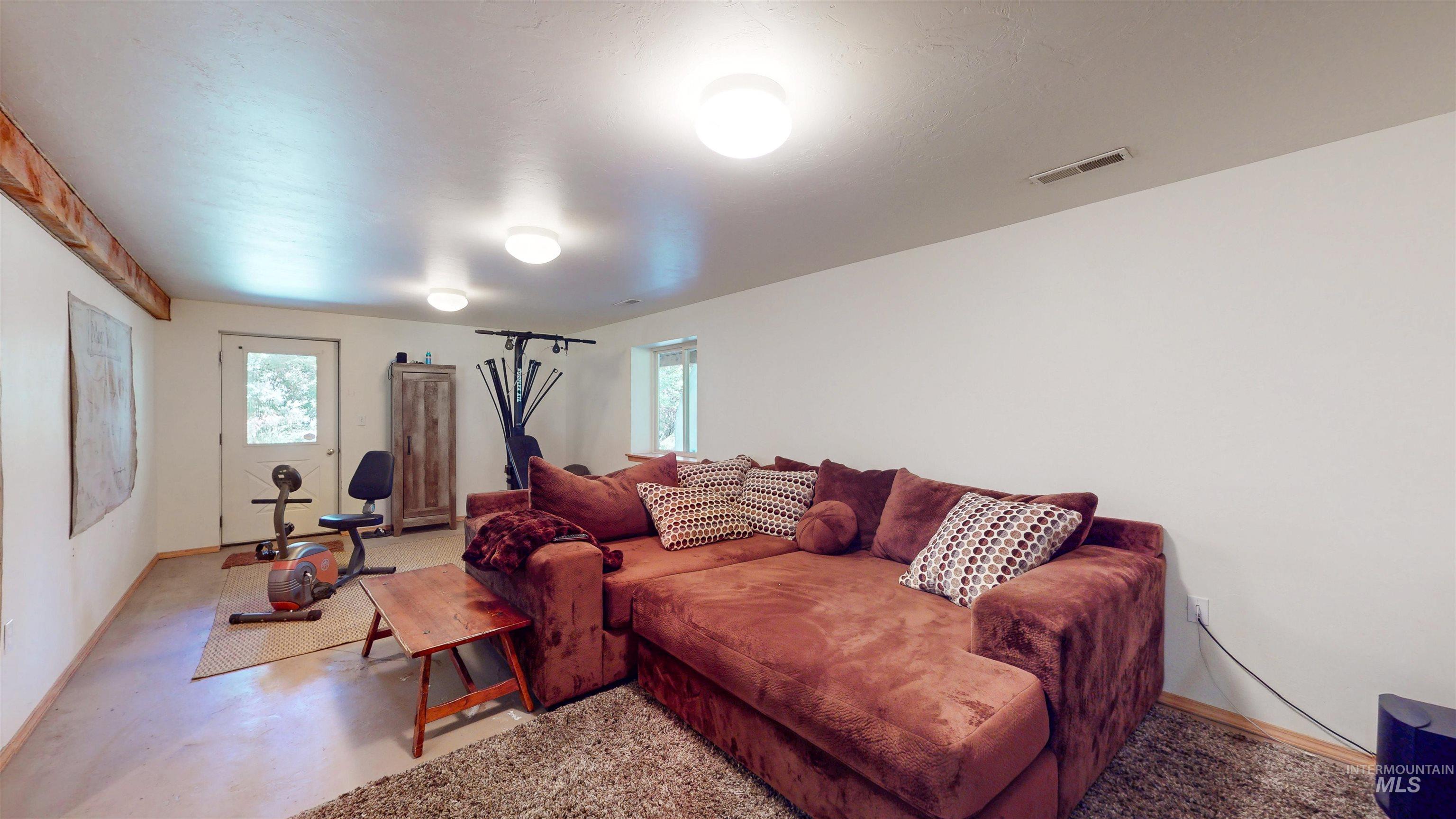 Living area featuring plenty of natural light and concrete flooring