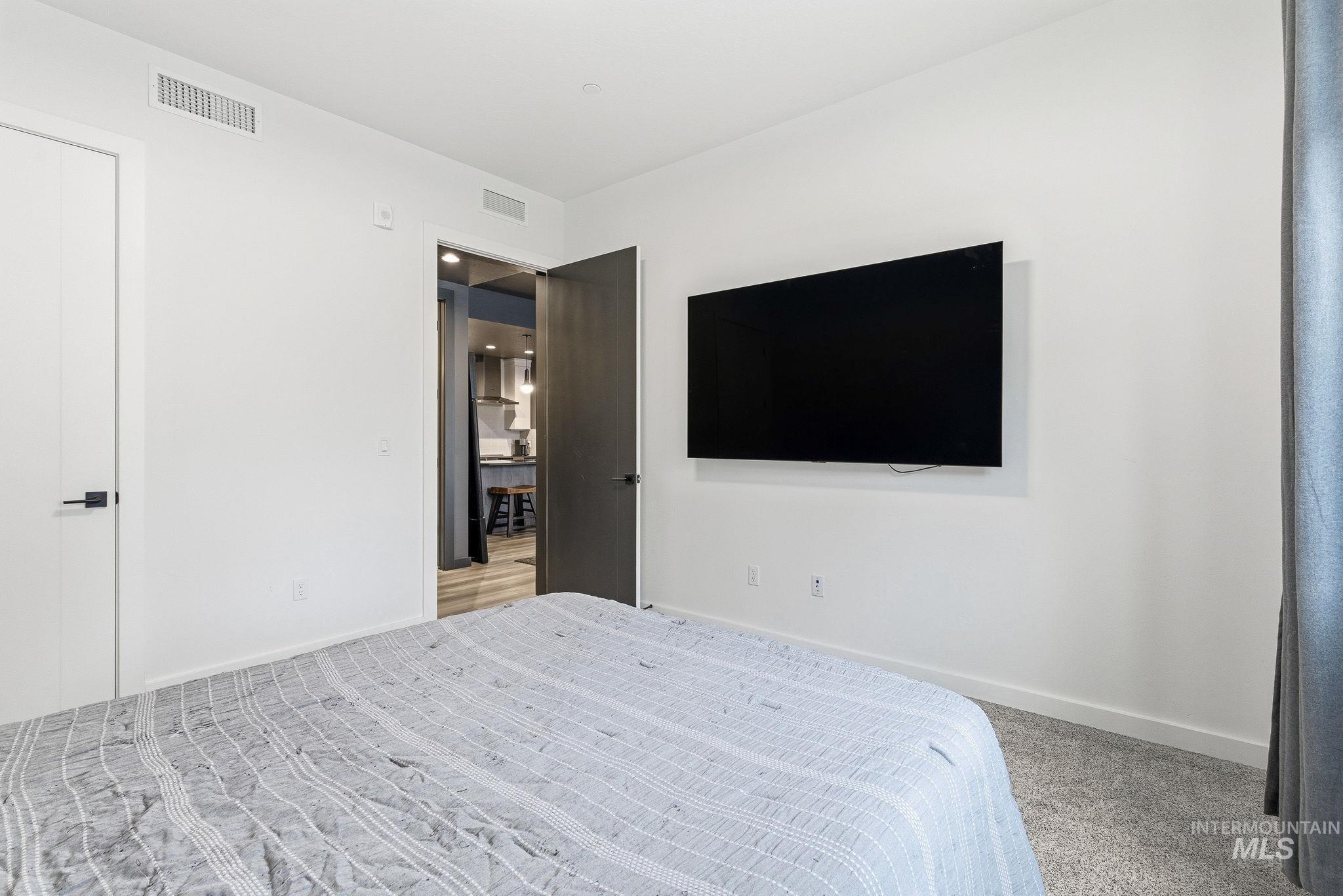 Bedroom with carpet flooring and baseboards