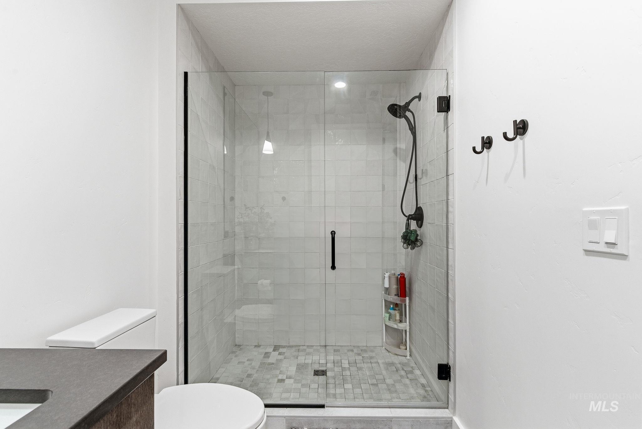 Bathroom with vanity and a stall shower
