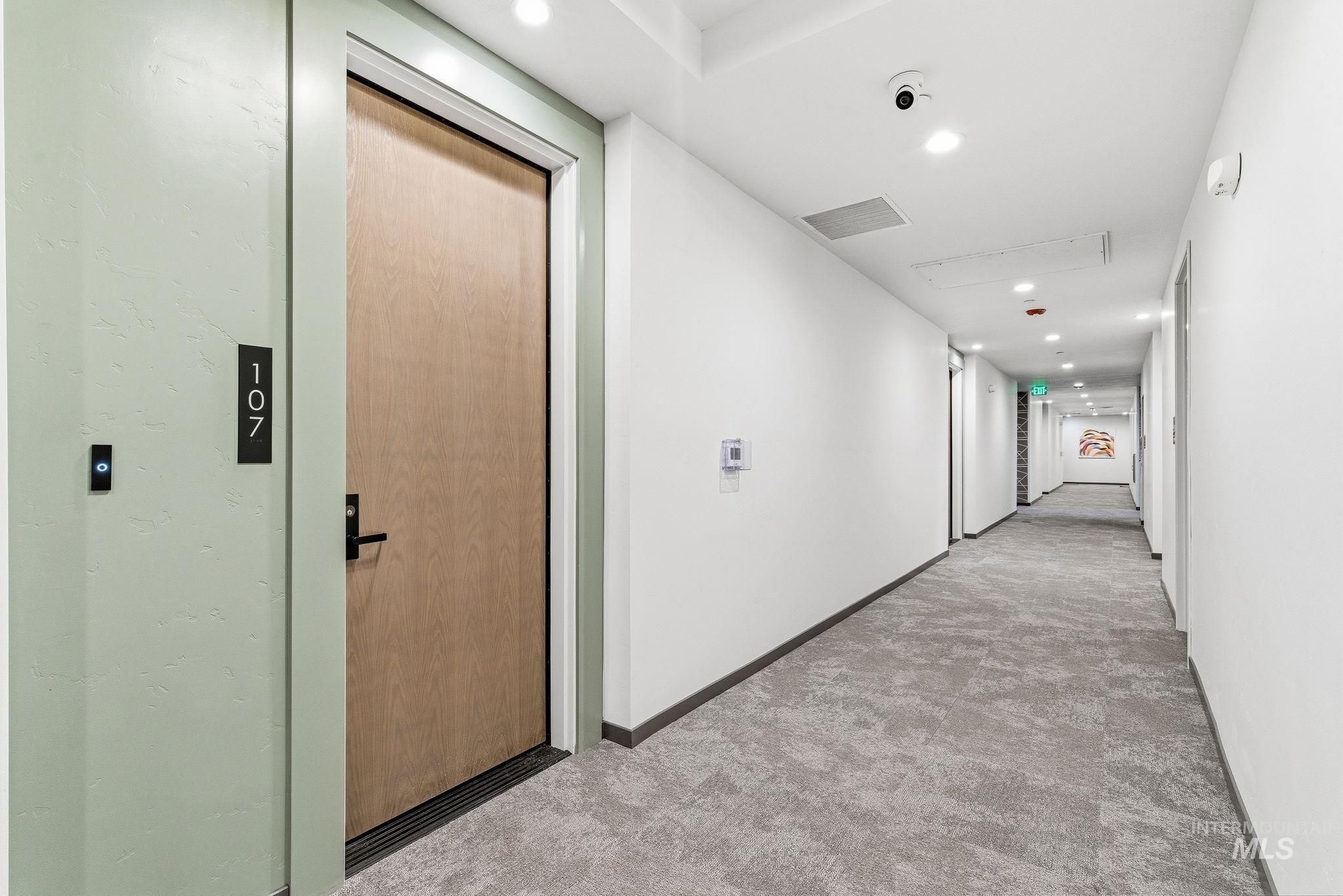 Hall with recessed lighting and carpet