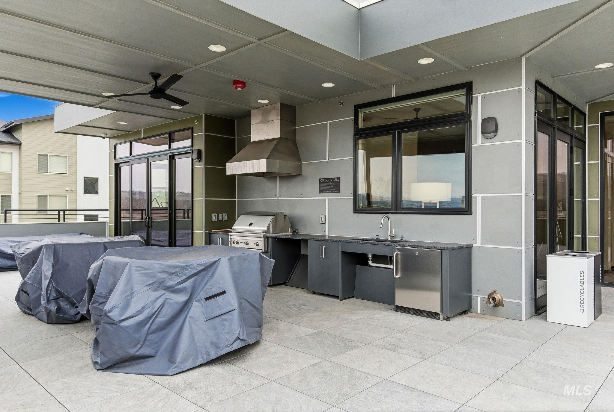 View of patio / terrace with area for grilling and a ceiling fan