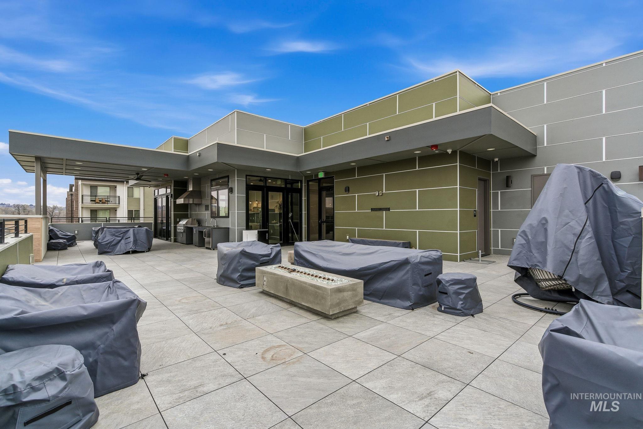 View of patio / terrace with a fire pit and a grill