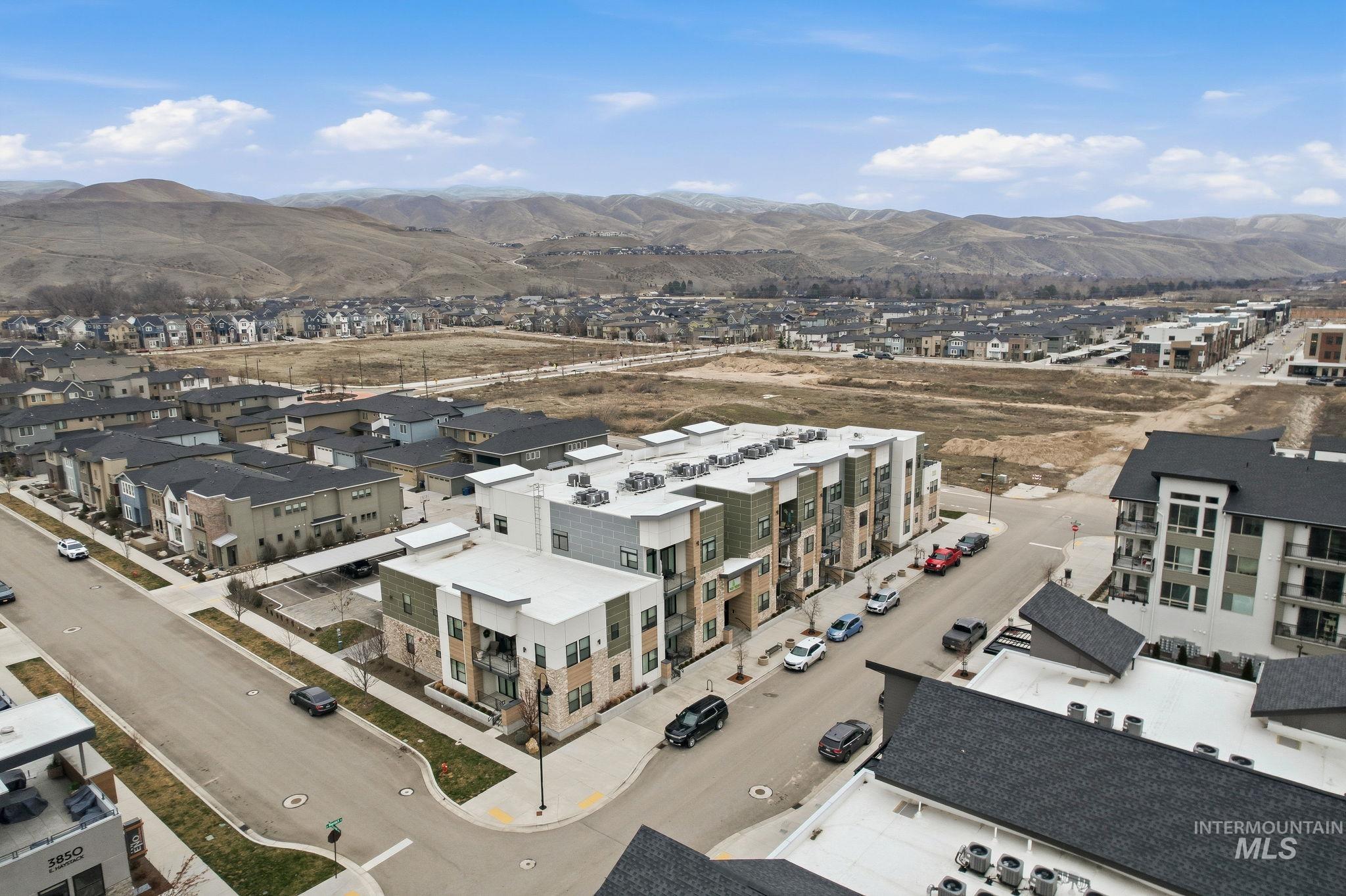 Aerial perspective of suburban area with a mountainous background