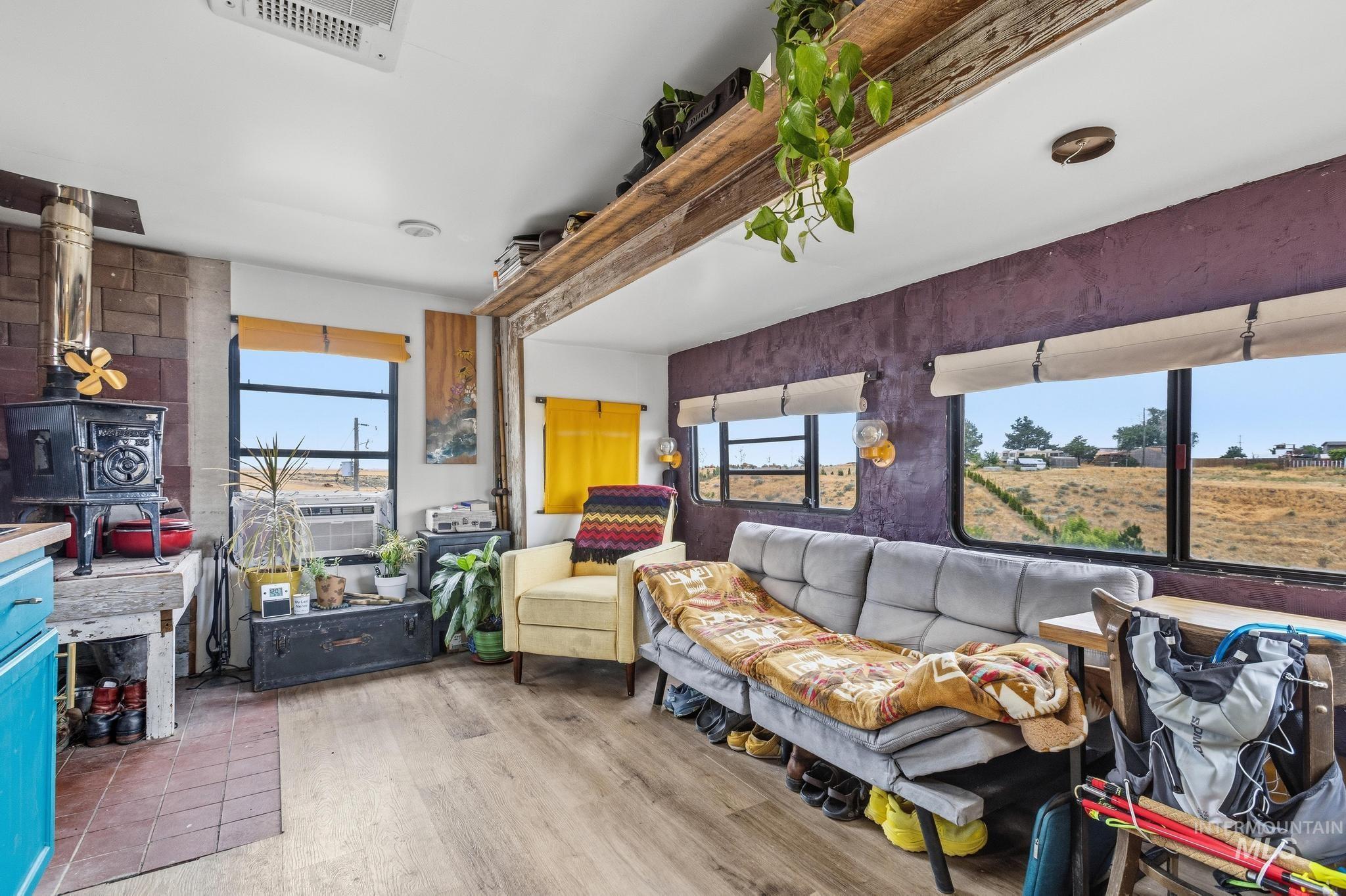 Living area featuring wood-finish flooring and multiple windows