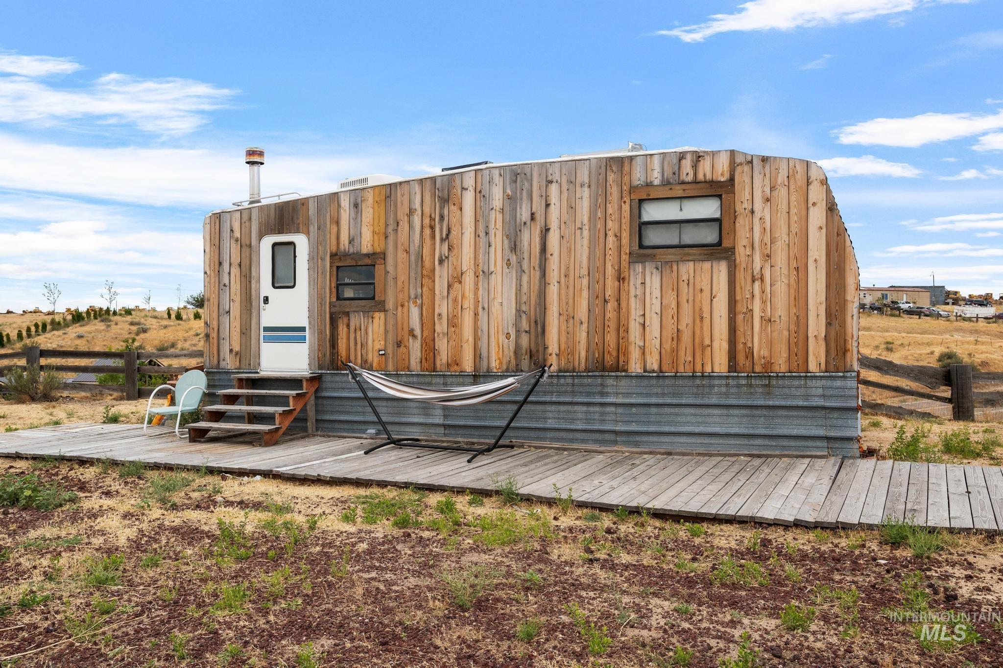 Compact structure featuring a natural wood siding and corrugated metal base