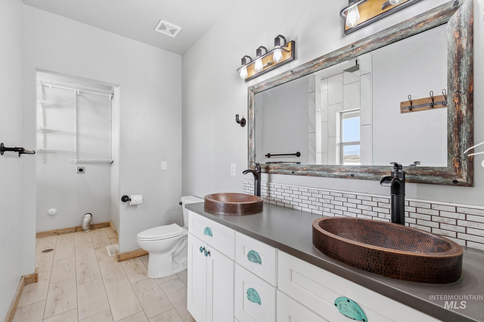 Dual copper vessel sinks with matte black fixtures