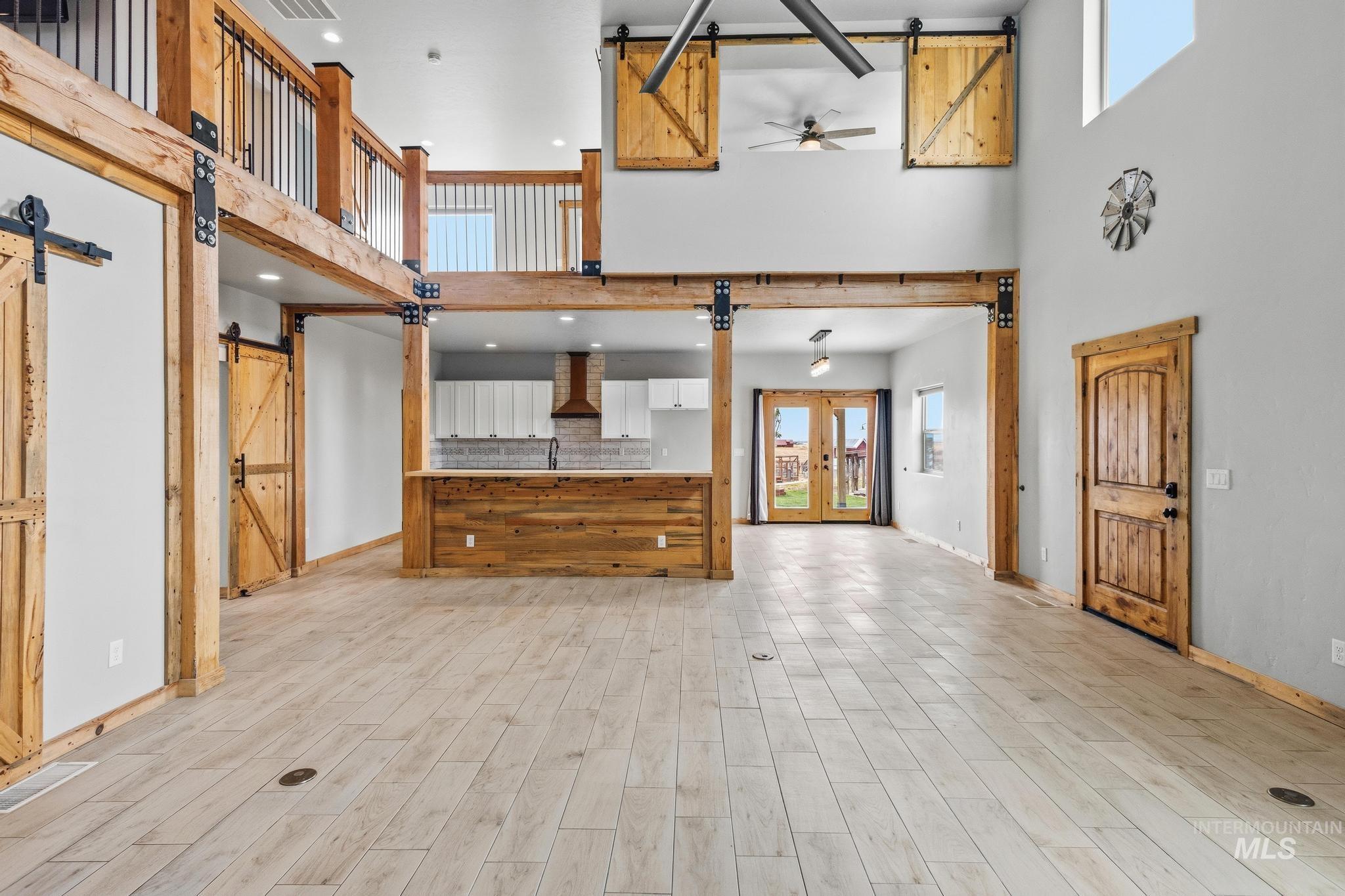 Great room with soaring ceilings and wood-finish flooring