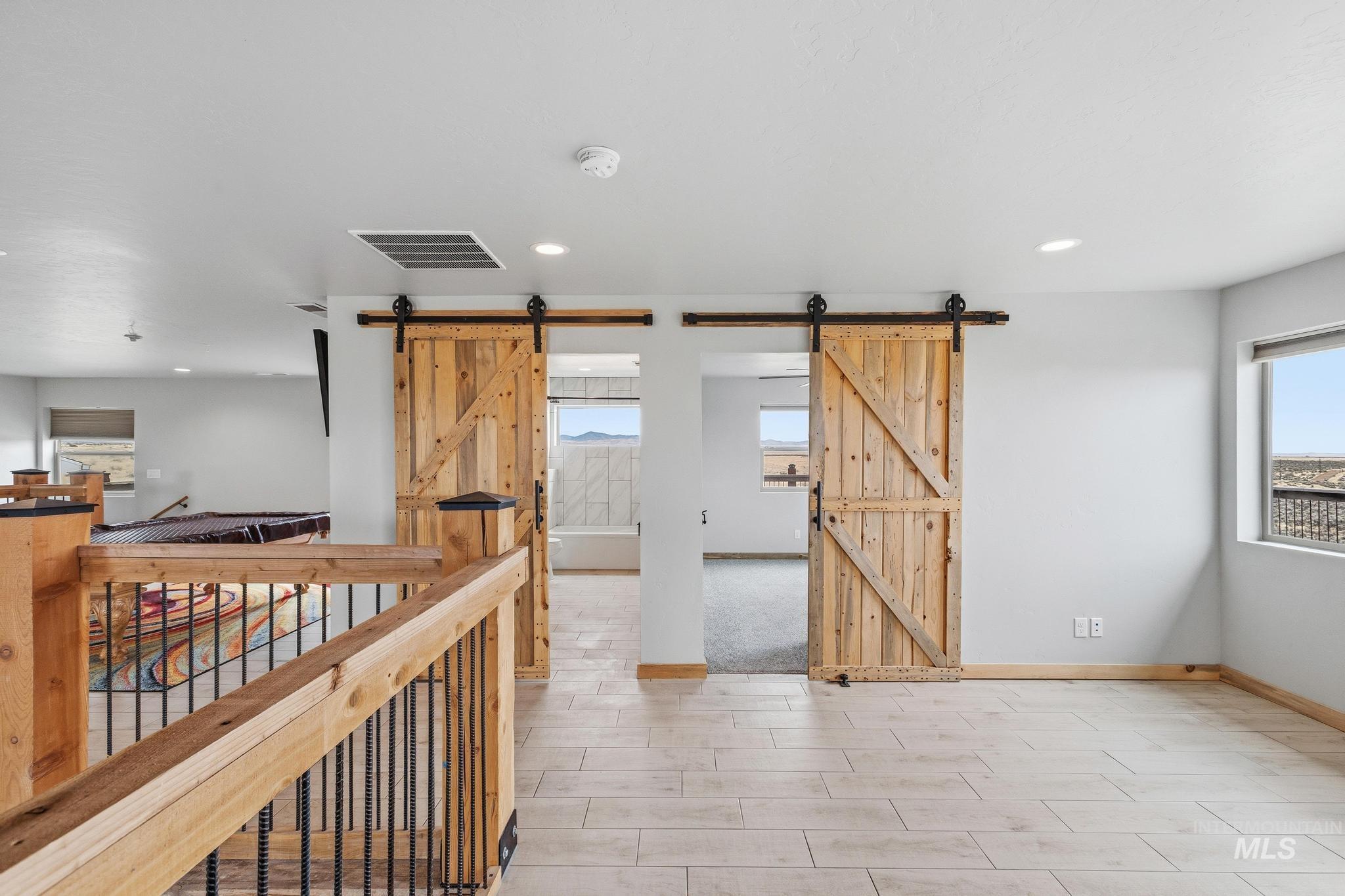 Light wood-finish flooring complements the neutral wall tones