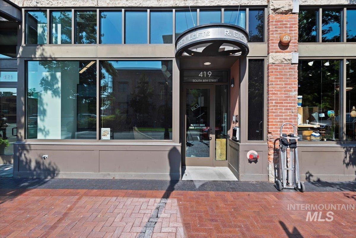 View of exterior entry featuring brick siding