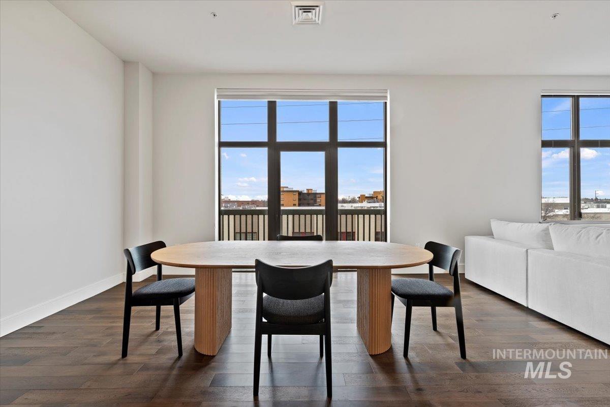 Dining room featuring dark wood finished floors and plenty of natural light