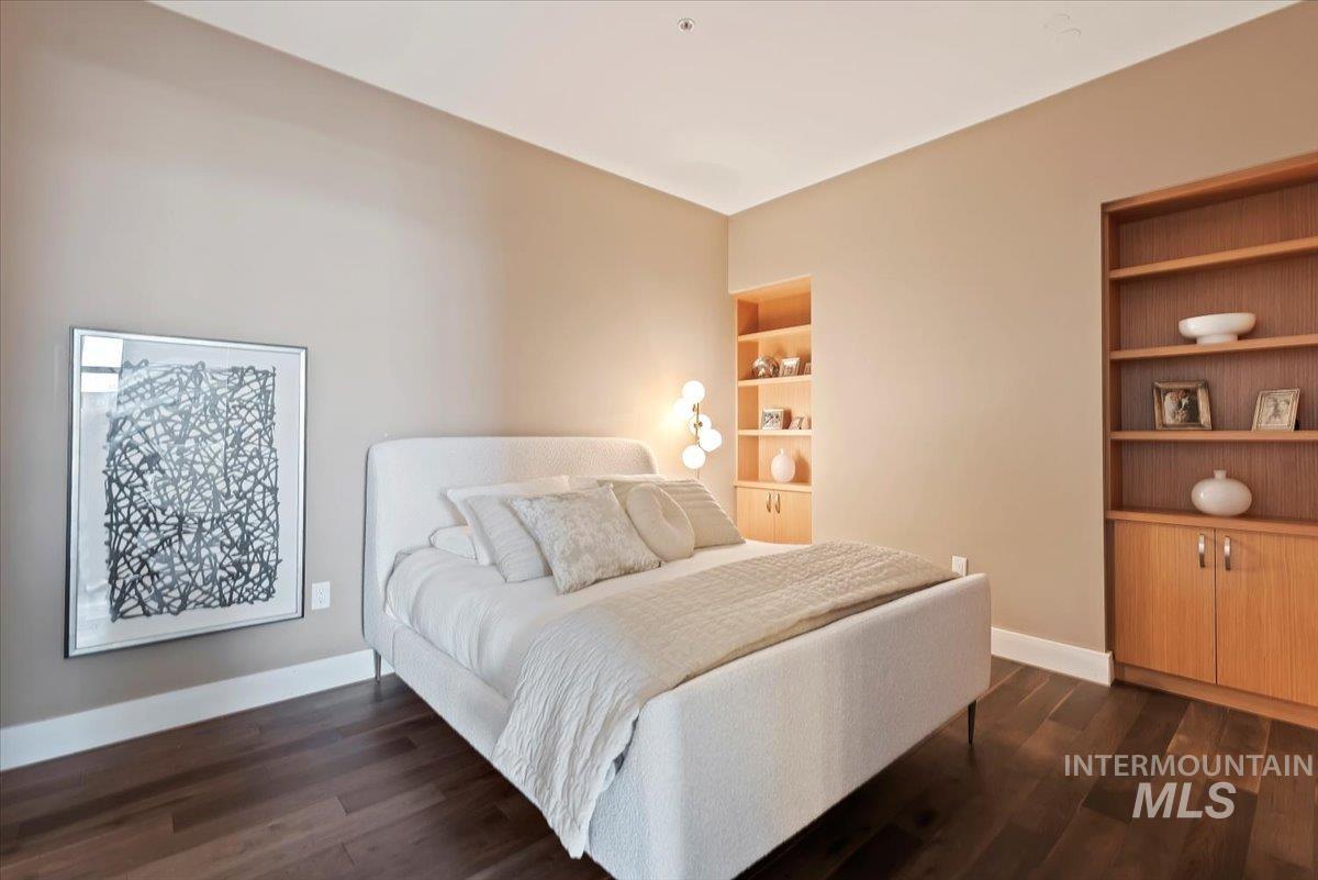 Bedroom with dark wood-style floors