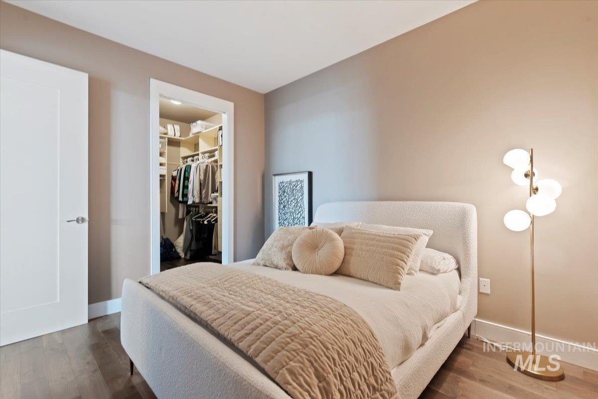 Bedroom featuring wood finished floors and a walk in closet