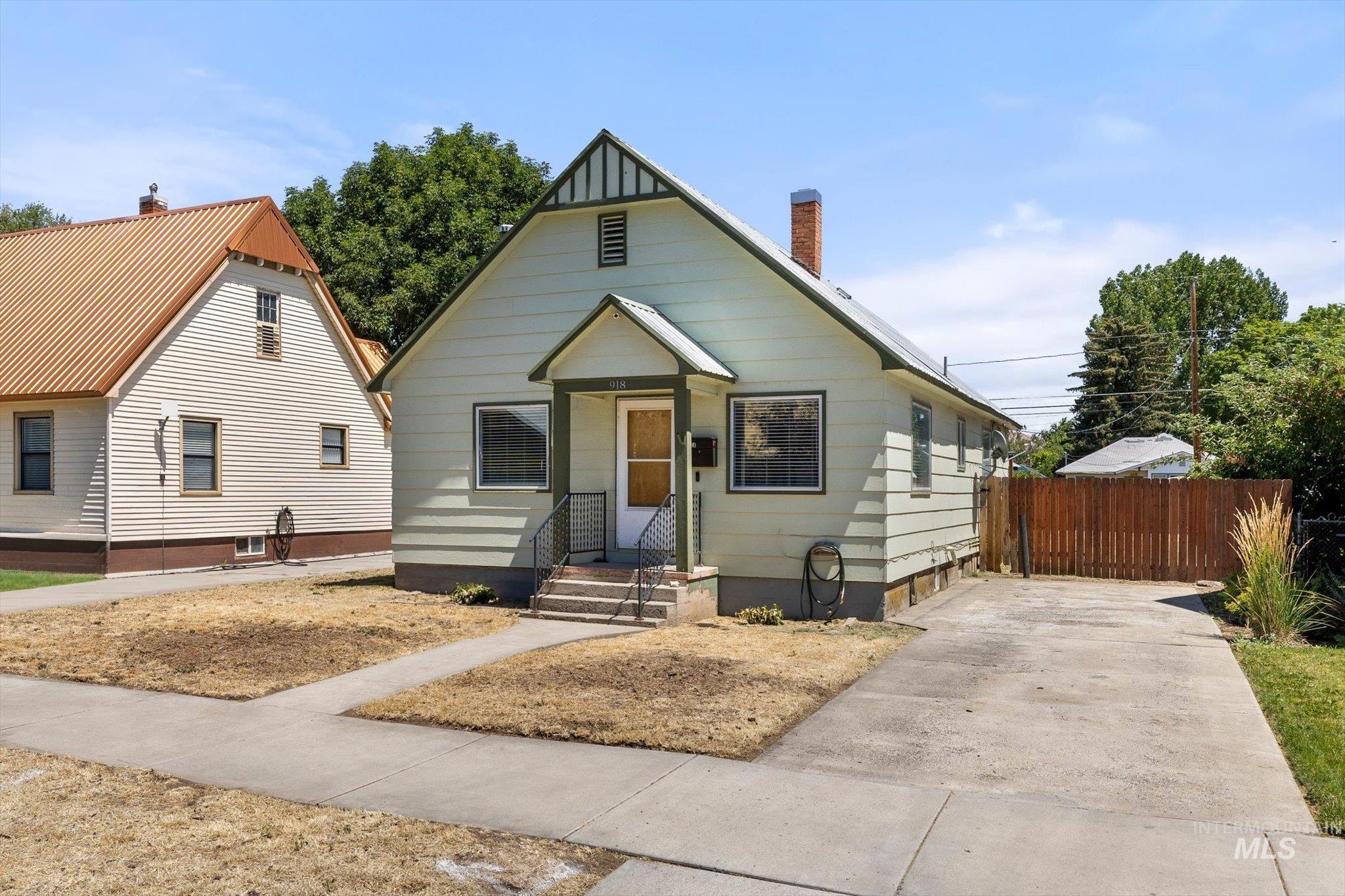 Light green siding exterior with dark green trim accents