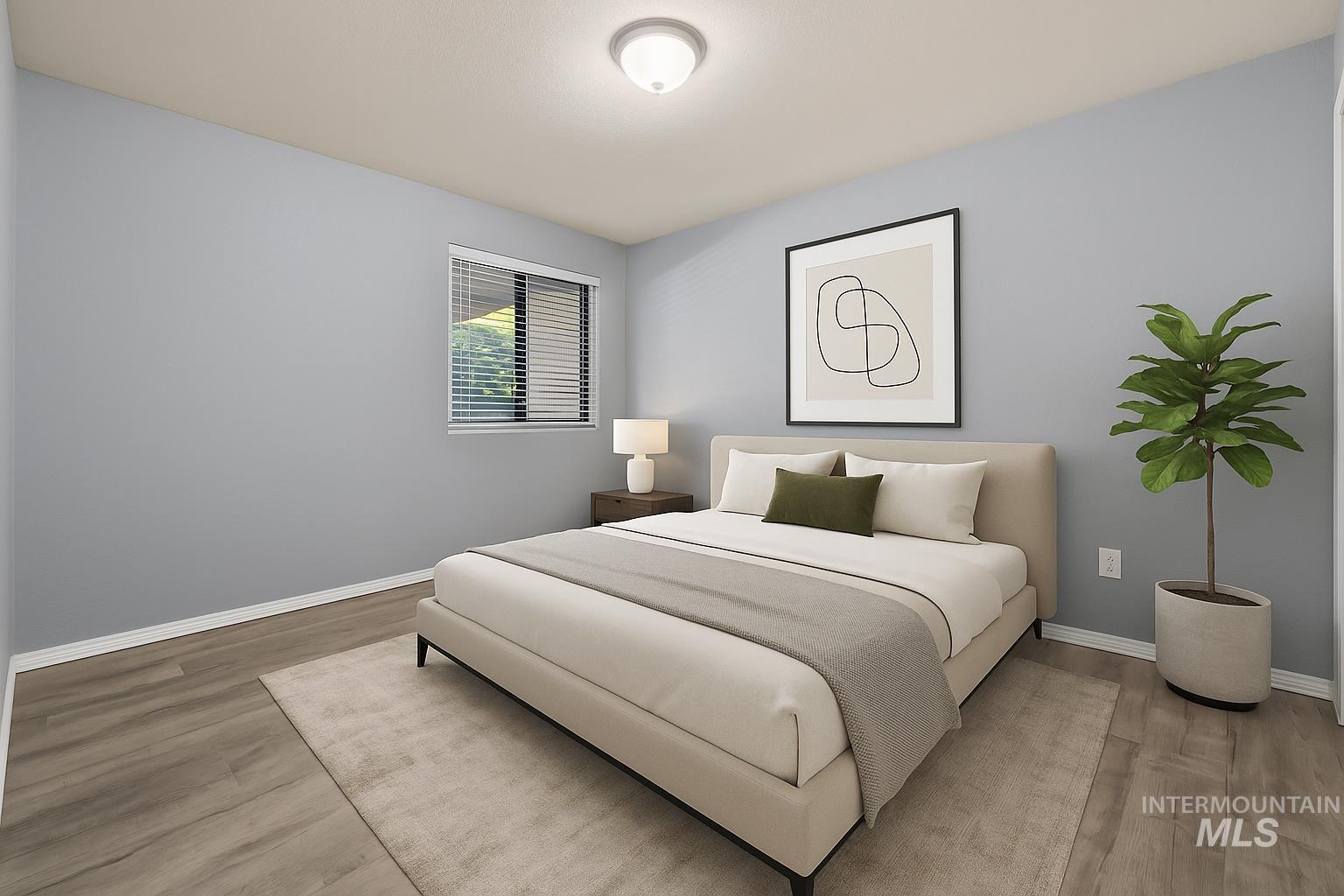 Bedroom featuring wood finished floors and baseboards