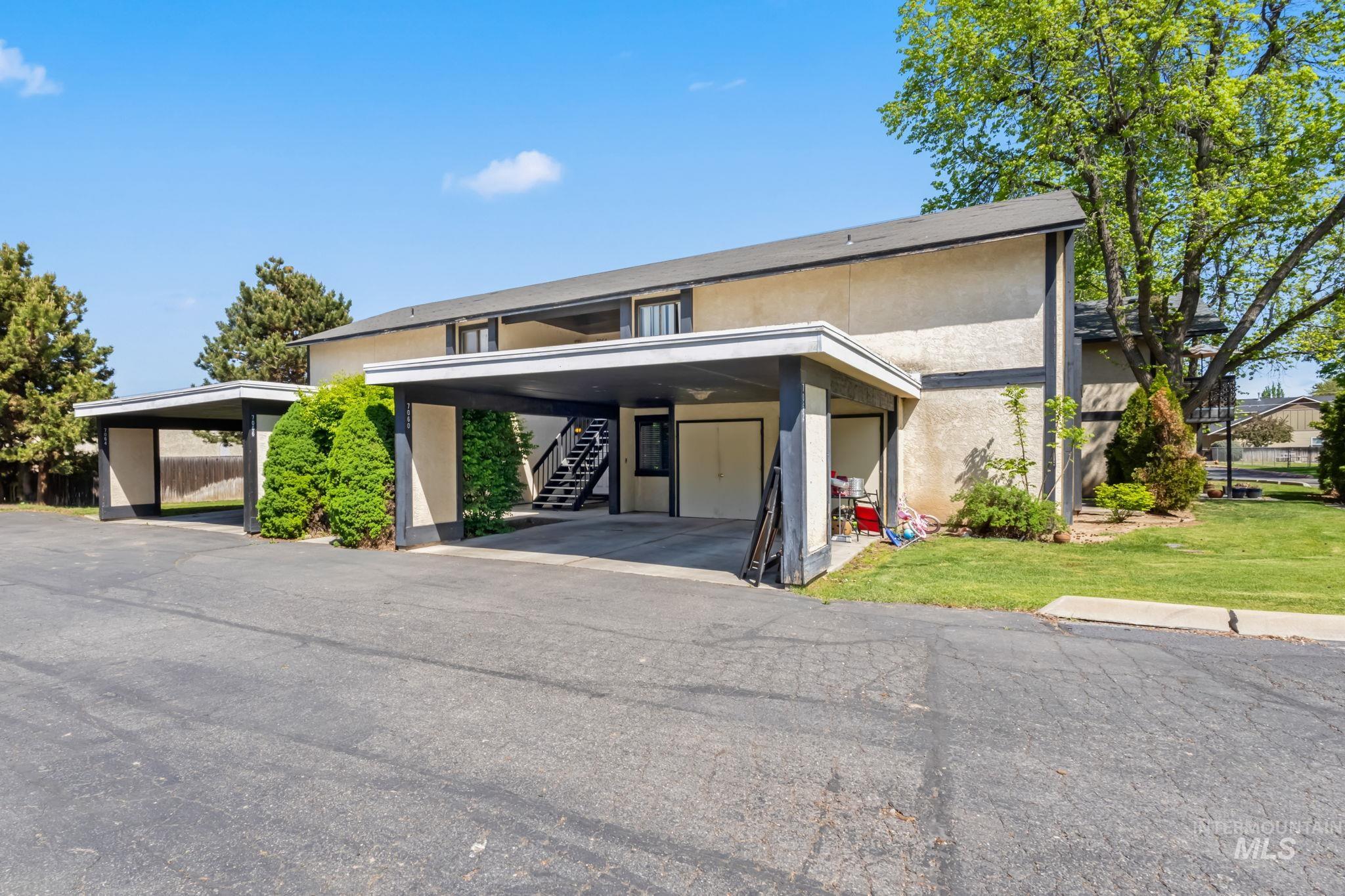 View of front of home featuring stairs and stucco siding