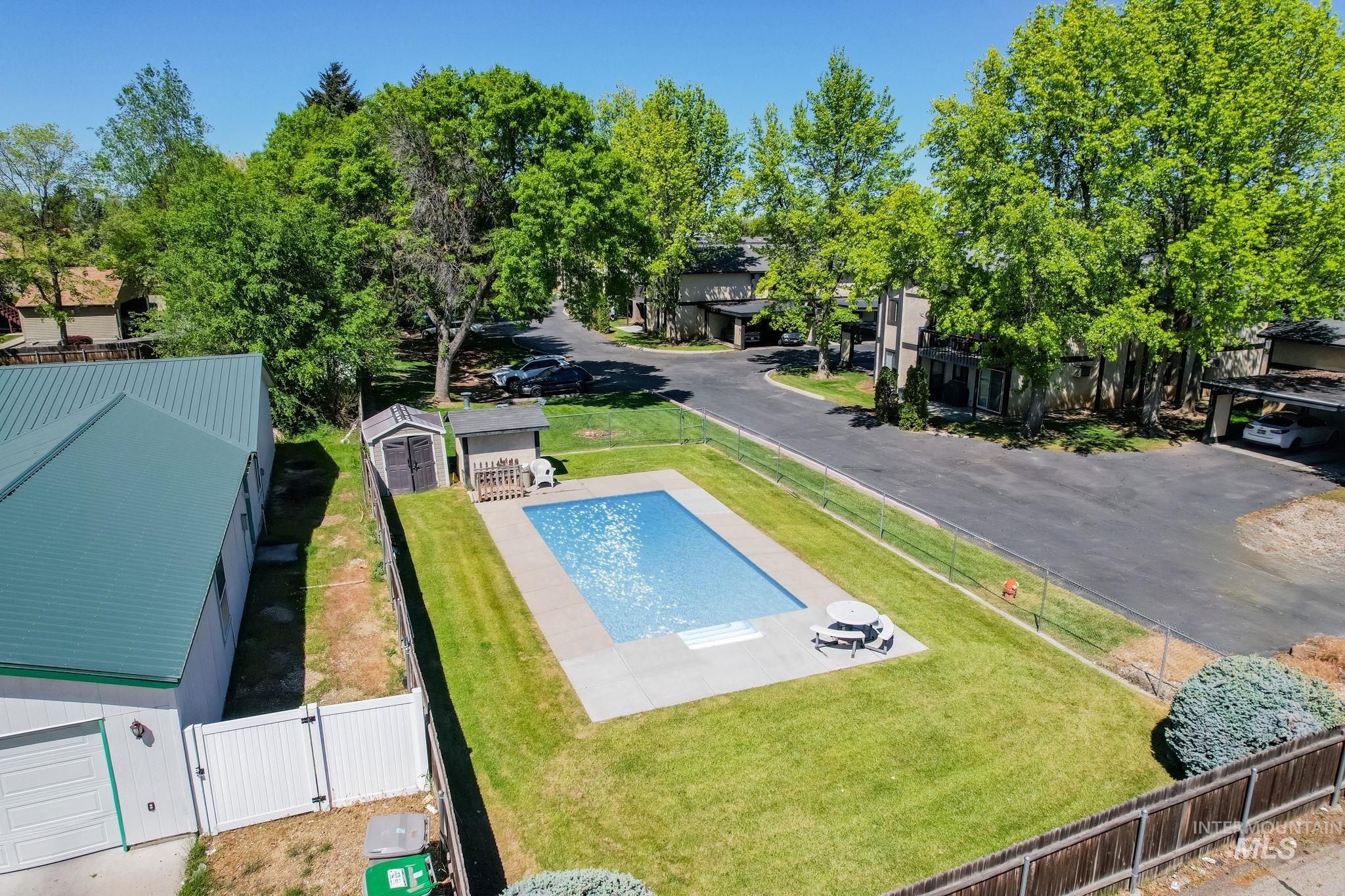 View of pool with a gate and an outdoor structure