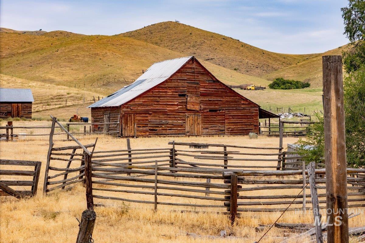Horse barn with a rural view and a mountain view