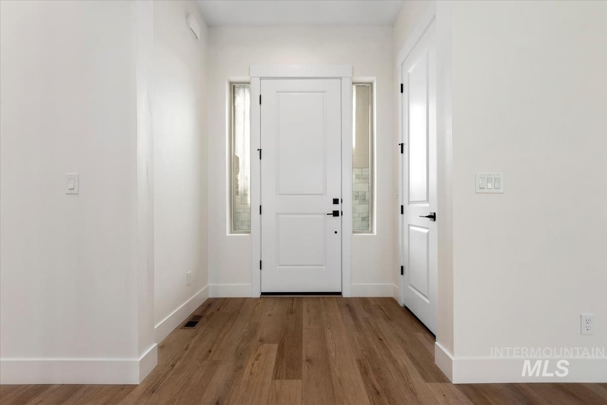 Entrance foyer with wood finished floors and baseboards