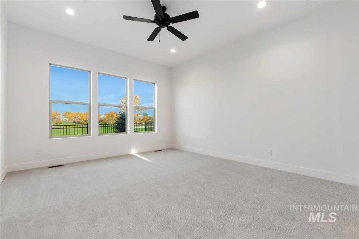Spare room with light colored carpet, recessed lighting, and ceiling fan