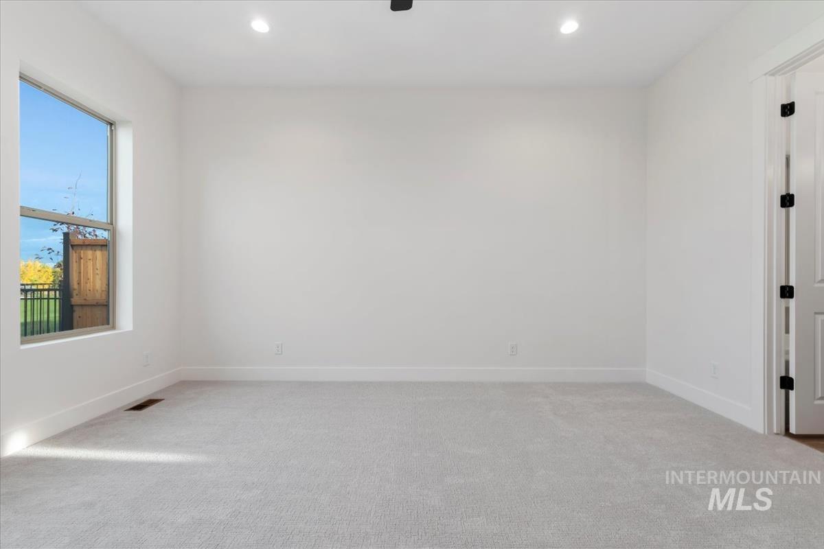 Unfurnished room featuring light carpet and recessed lighting