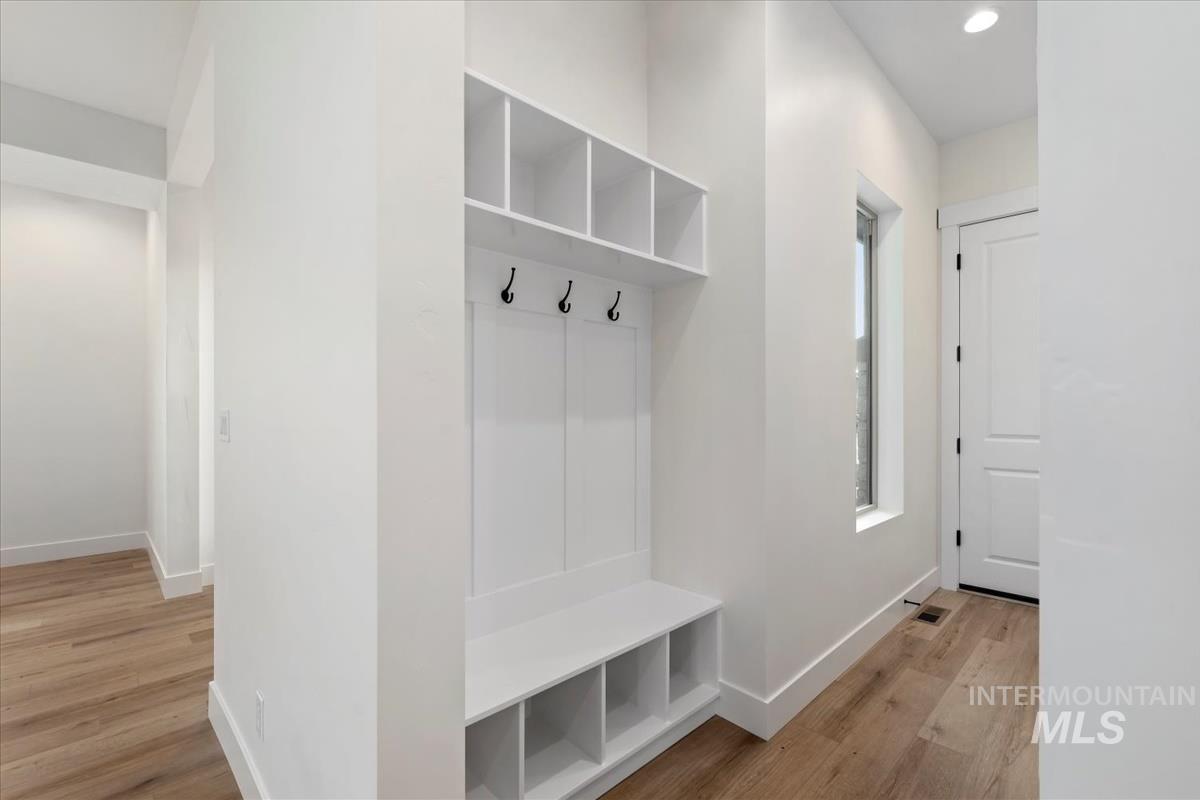 Mudroom with light wood-style floors and recessed lighting
