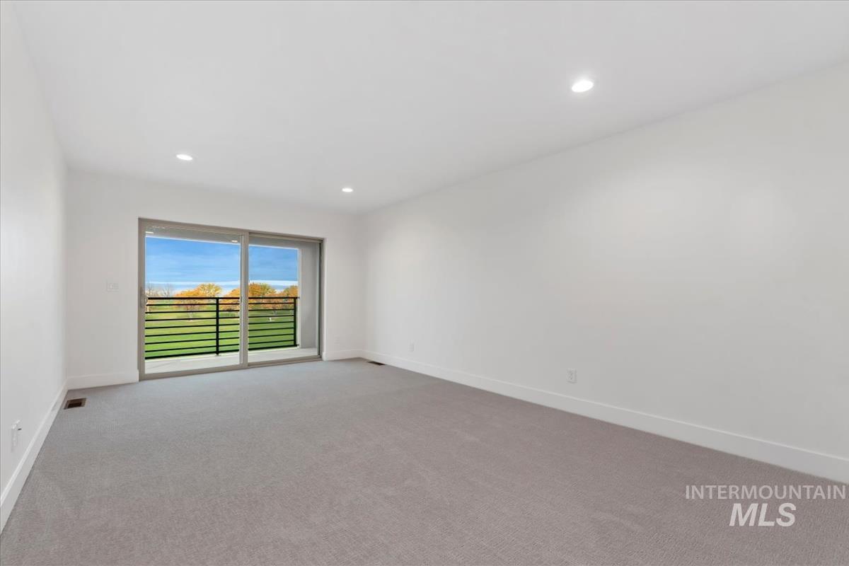 Empty room featuring light carpet and recessed lighting