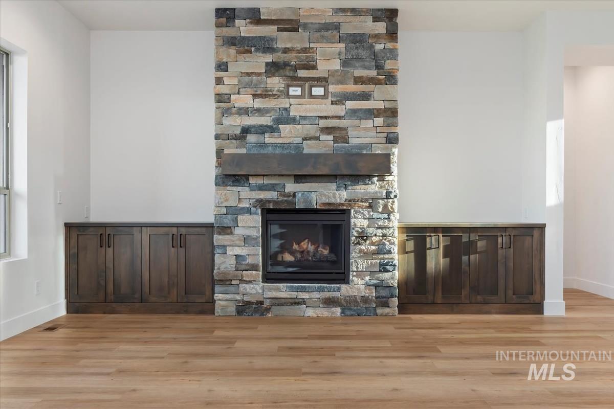 Unfurnished living room featuring a fireplace and light wood-style floors