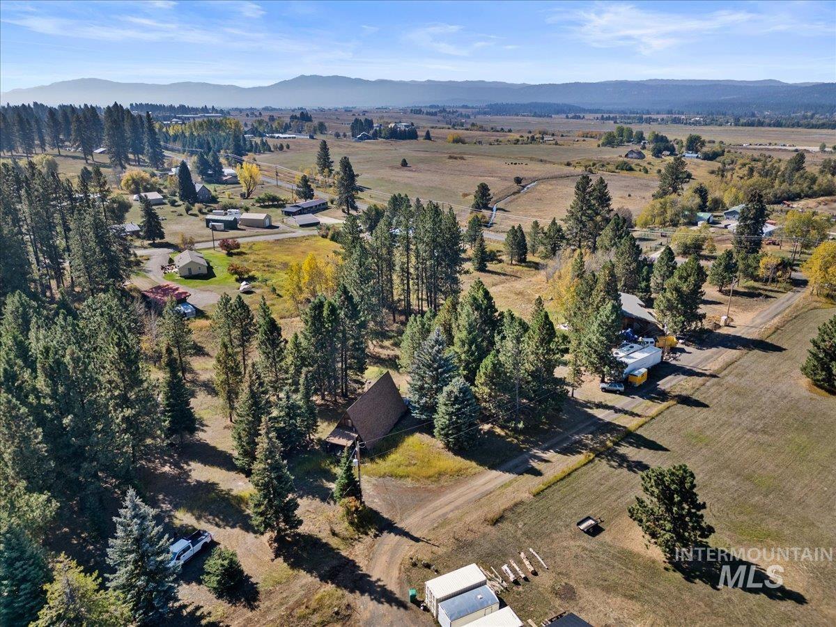 Aerial overview of property's location with a mountainous background and rural landscape