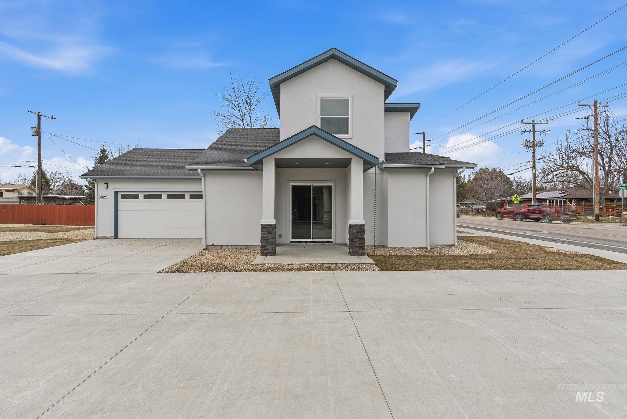 View of front of house featuring stucco siding, an attached garage, driveway, and a shingled roof