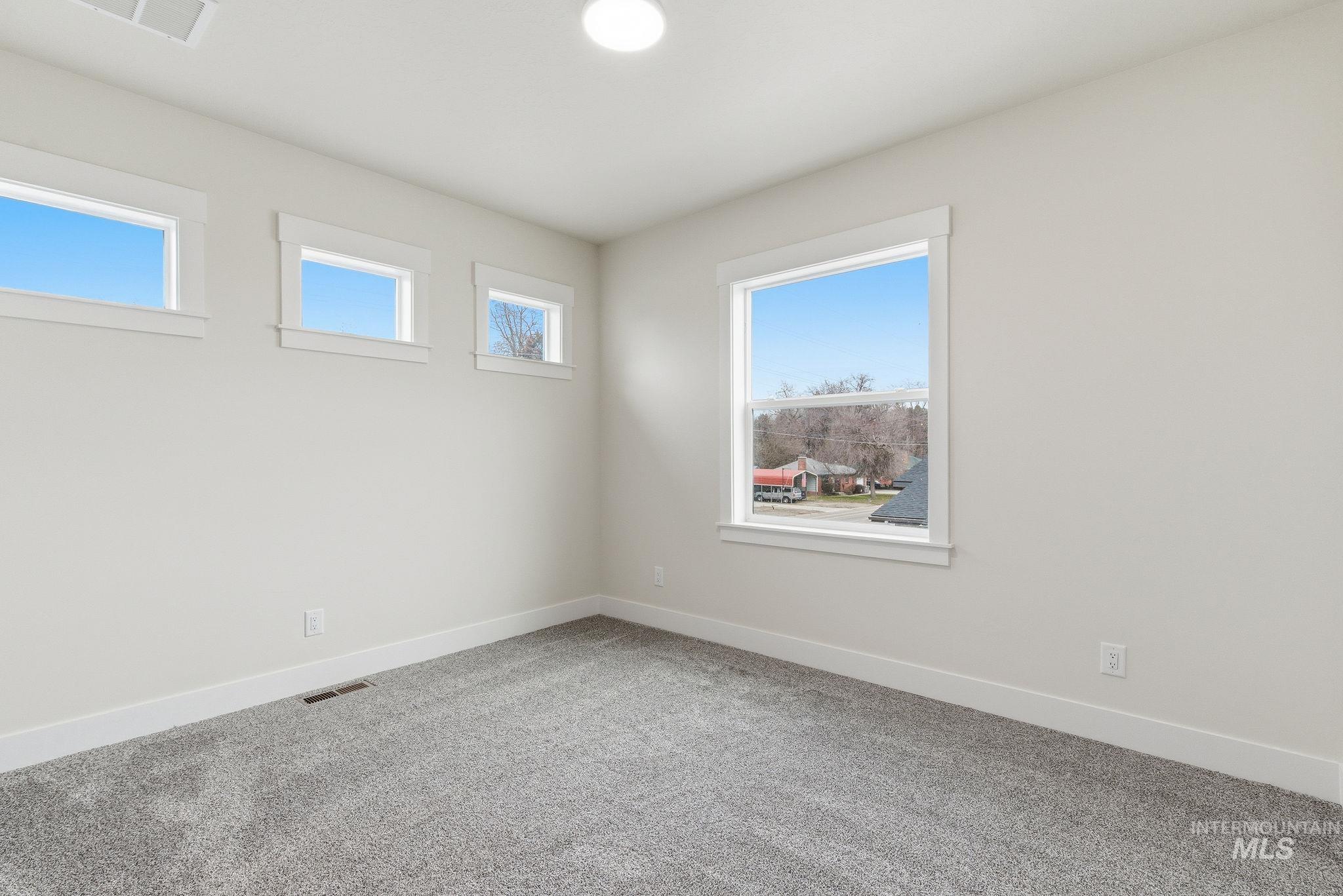 Unfurnished room featuring carpet floors and baseboards