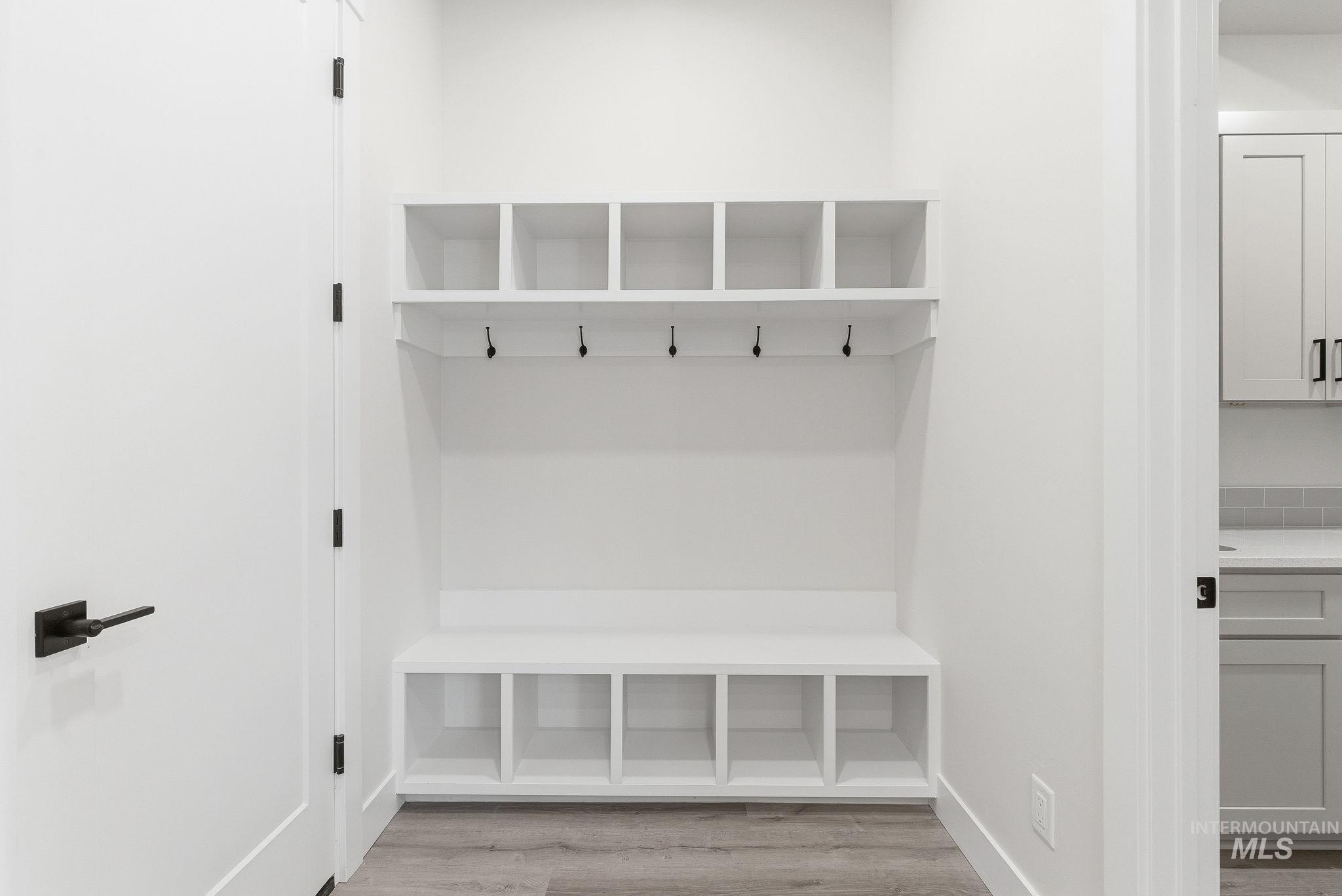 Mudroom featuring light wood-type flooring and baseboards