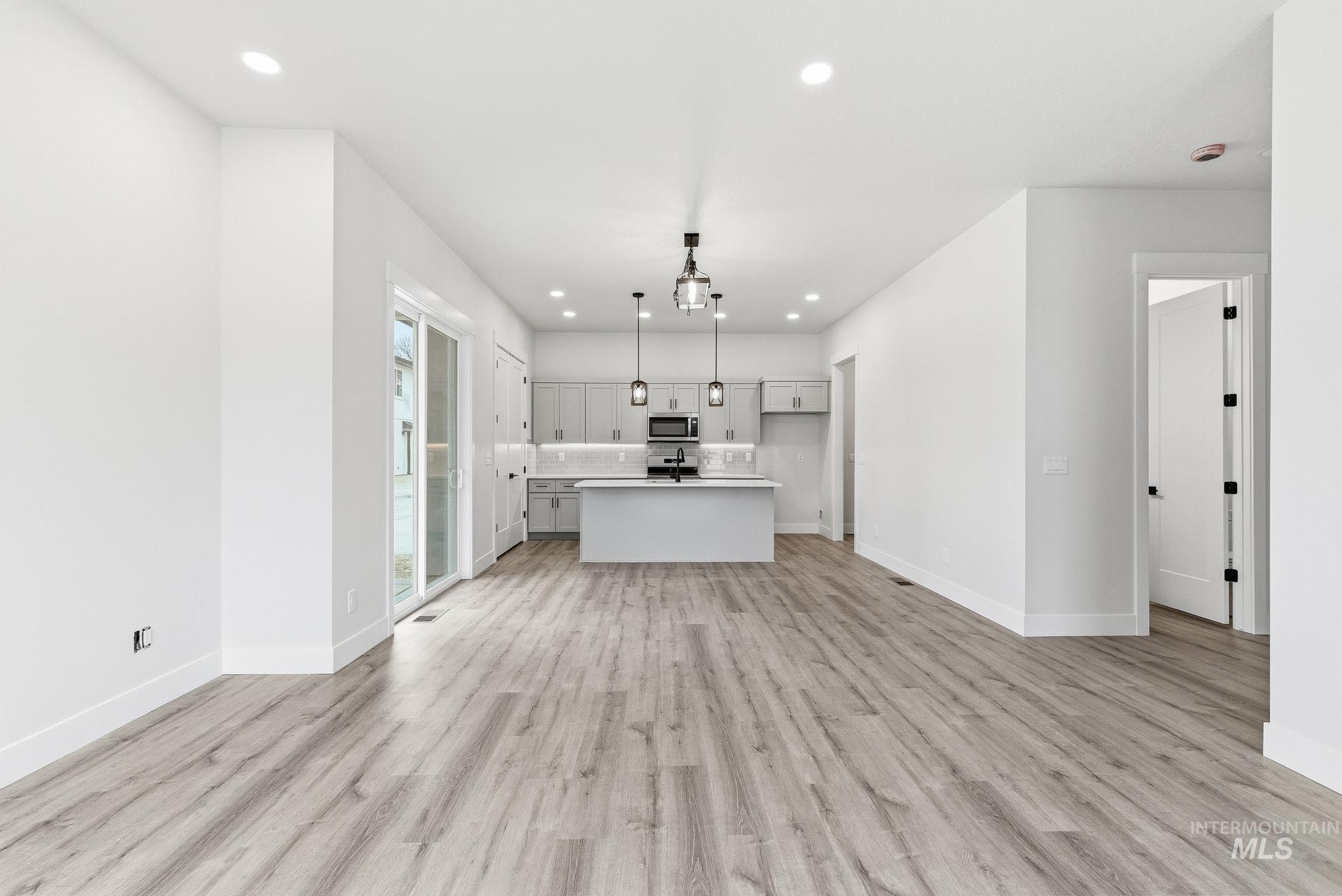 Unfurnished living room featuring recessed lighting and light wood-type flooring