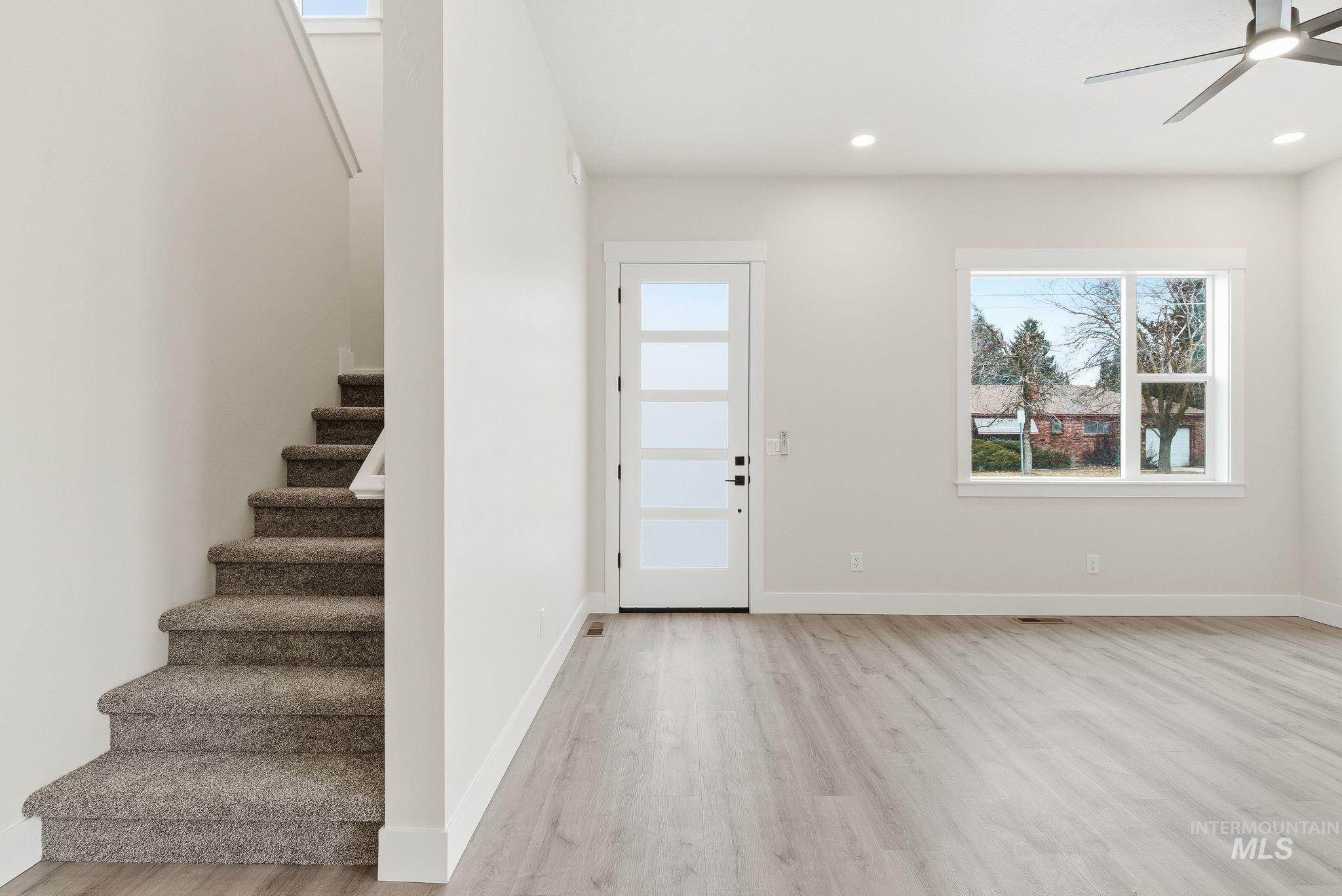 Foyer with light wood finished floors, ceiling fan, and recessed lighting