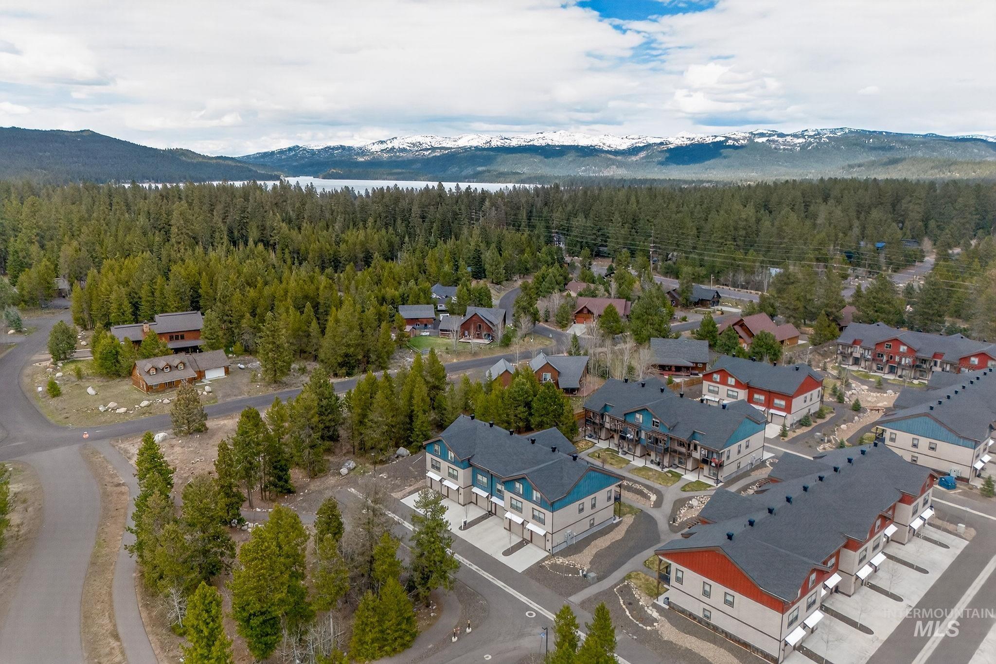 Contemporary townhome community featuring multi-level units with pitched roofs and distinct color palettes